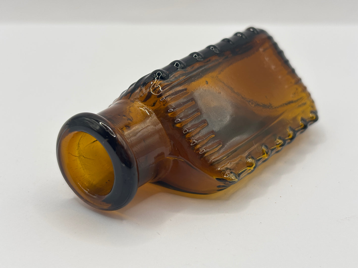 Old amber glass poison bottle