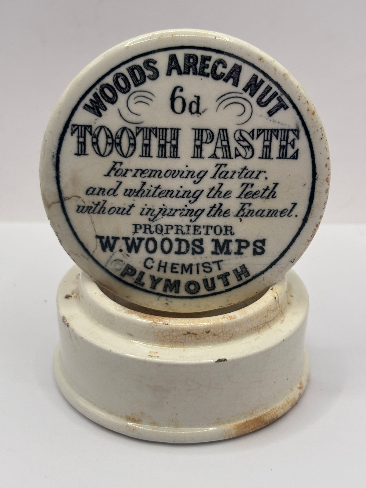 Old advertising lid and base. Woods areca nut tooth paste. Damaged