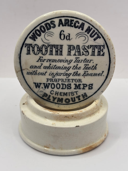 Old advertising lid and base. Woods areca nut tooth paste. Damaged