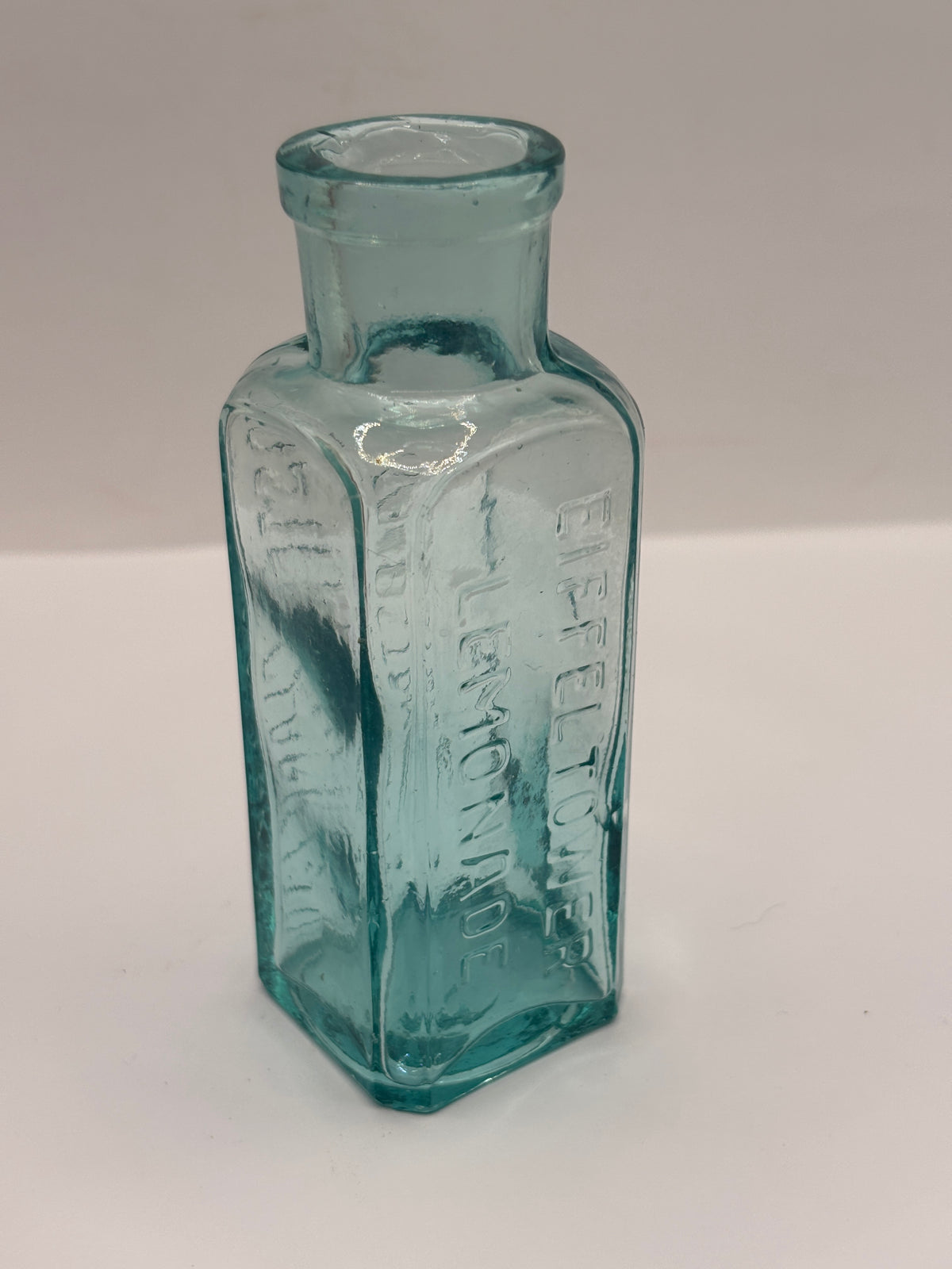 Old aqua glass advertising bottle, Eiffel tower Lemonade