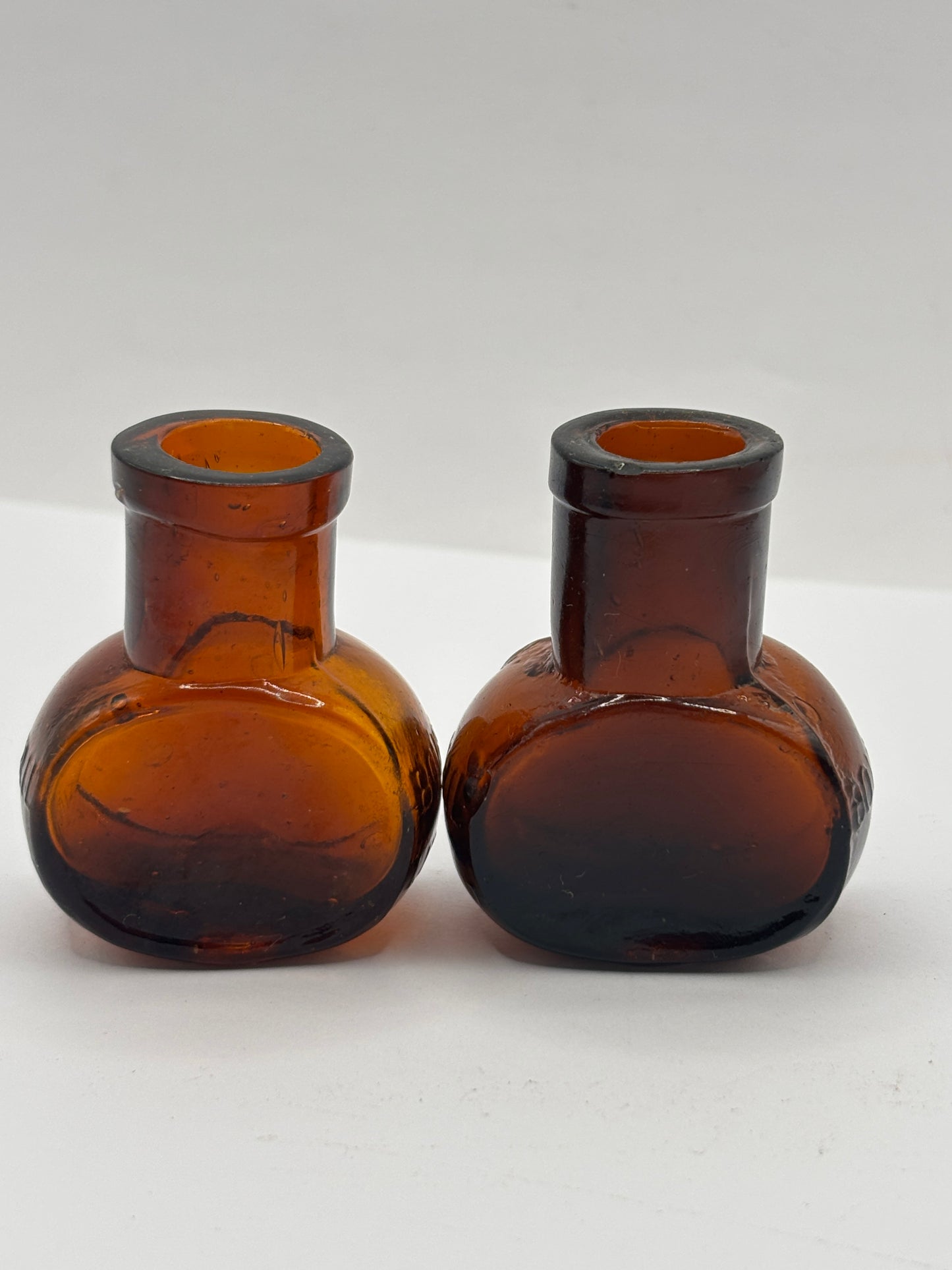 2 old mini bovril bottles