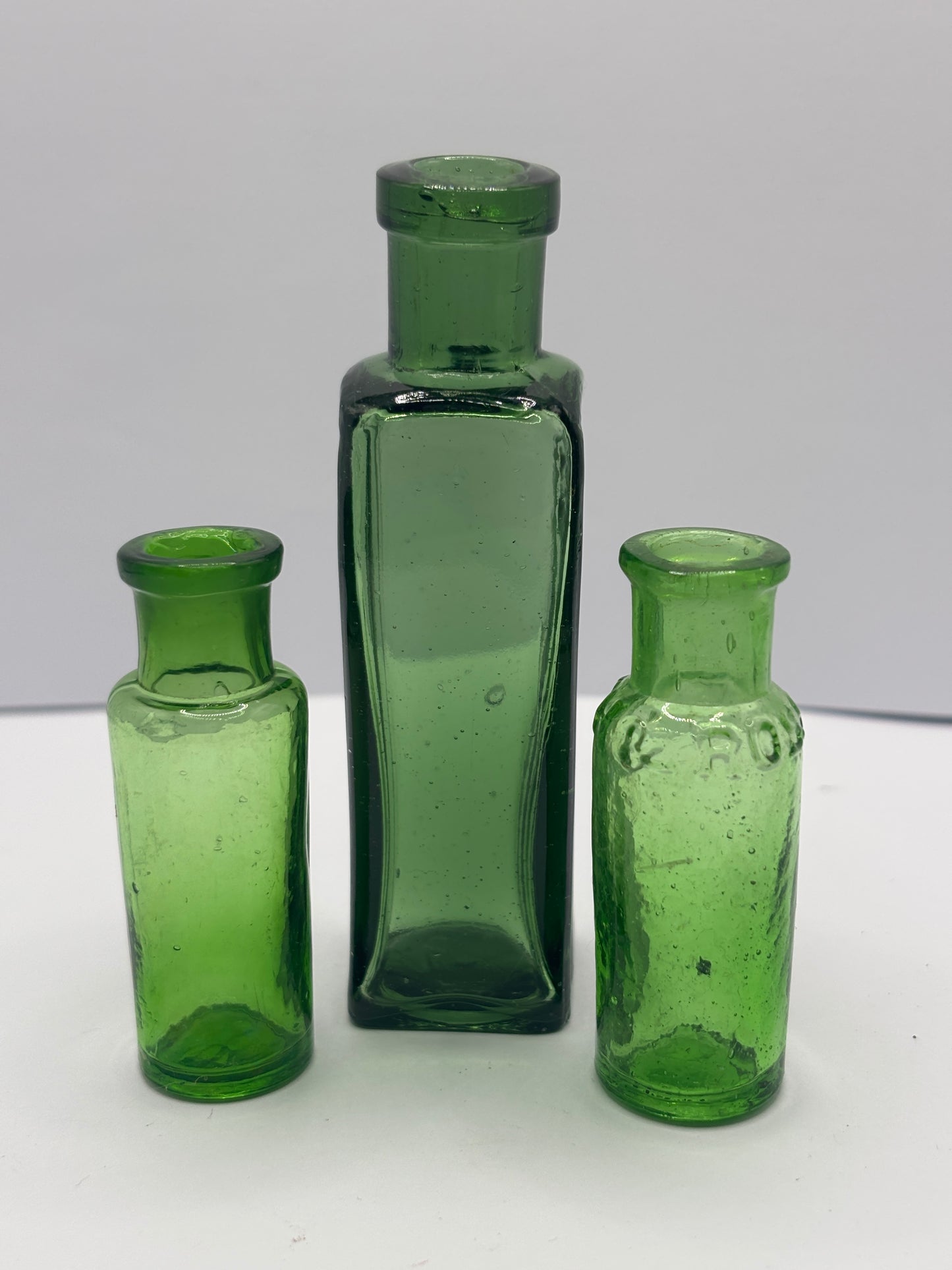 3 old green glass bottles