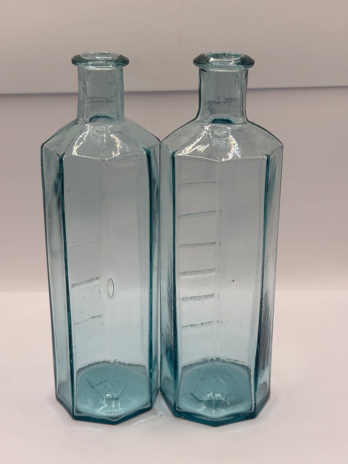2 old glass medicine bottles