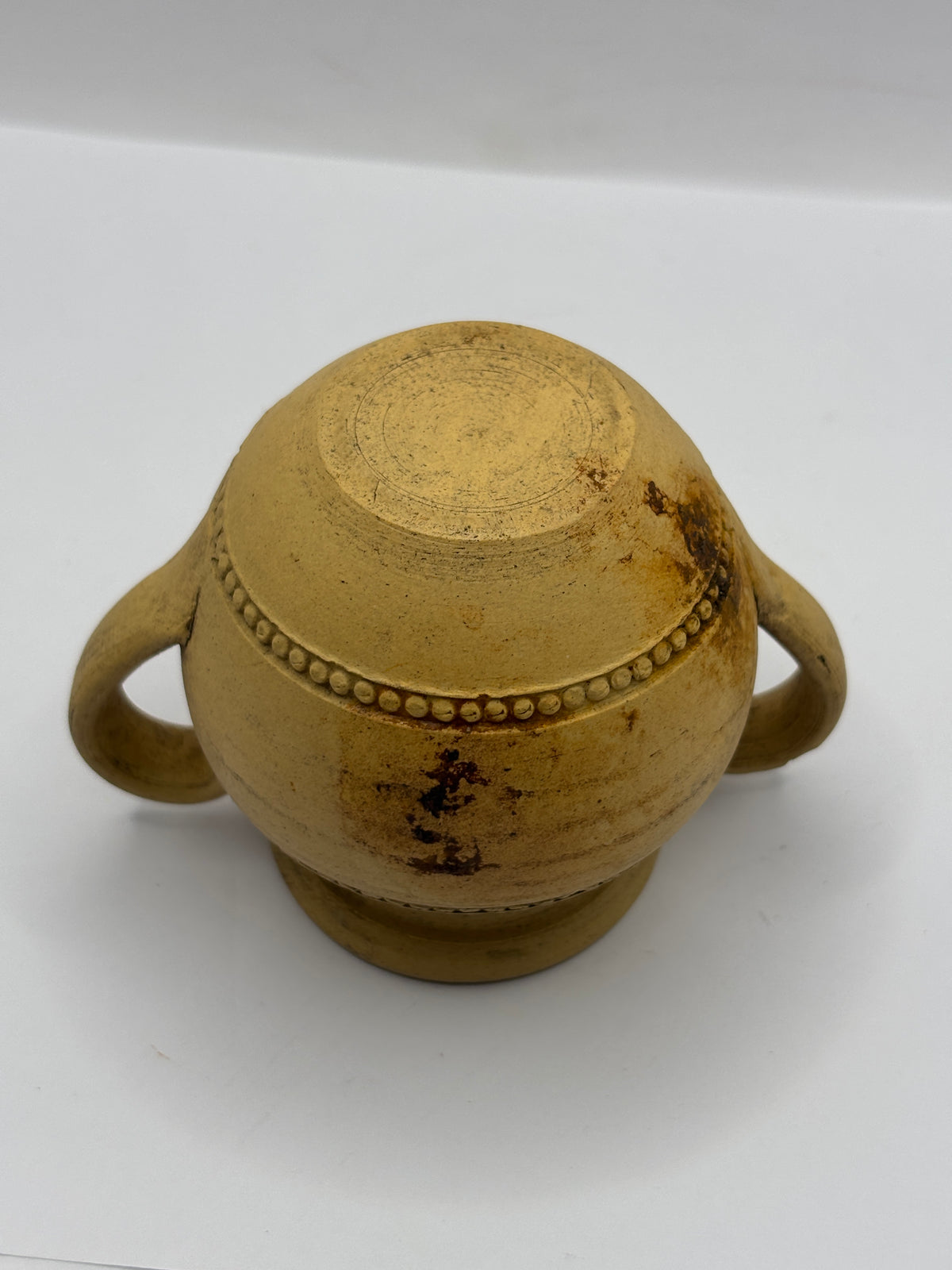 Old stained stoneware handled jug