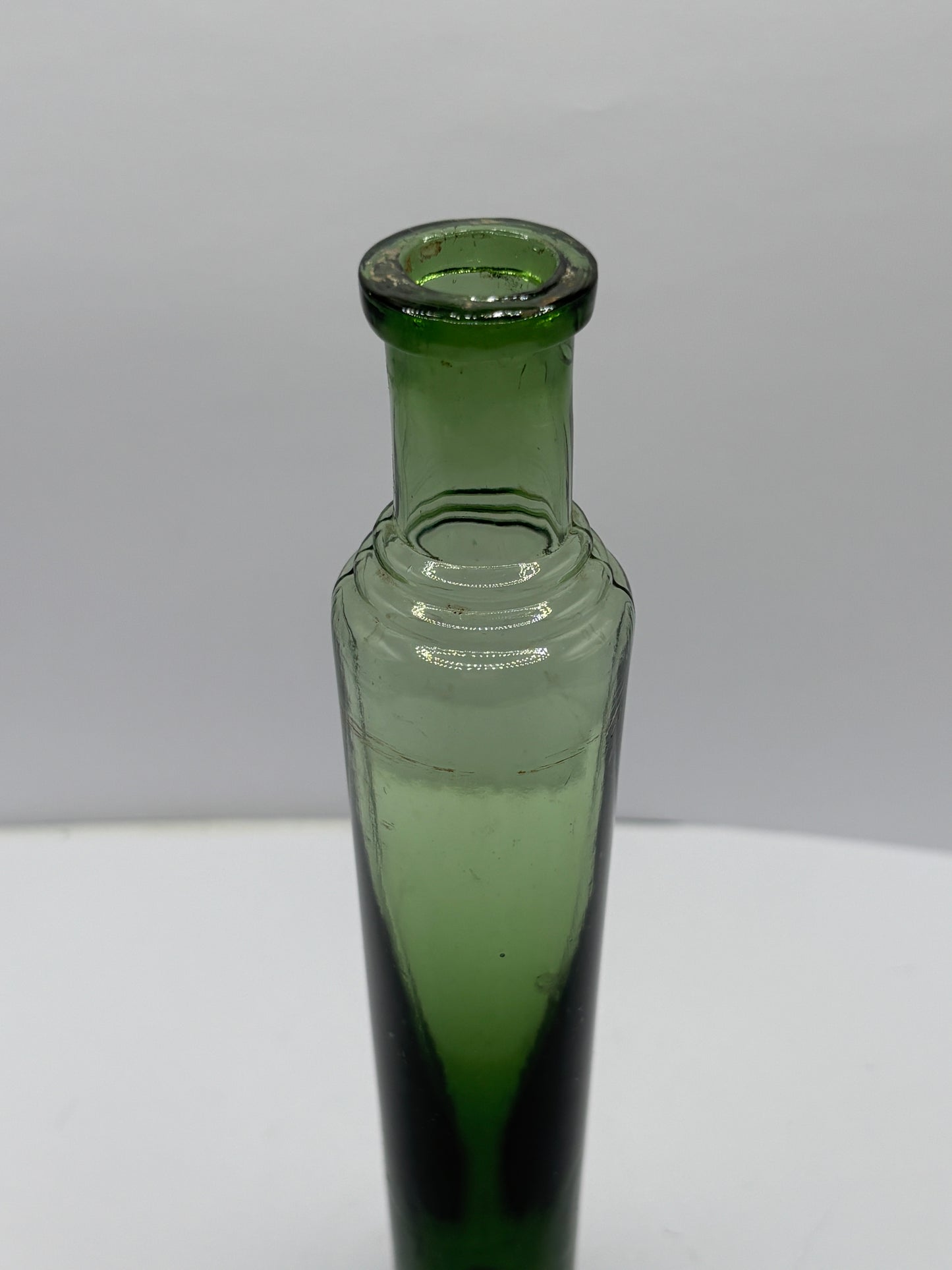Old green glass tall lavendar water bottle