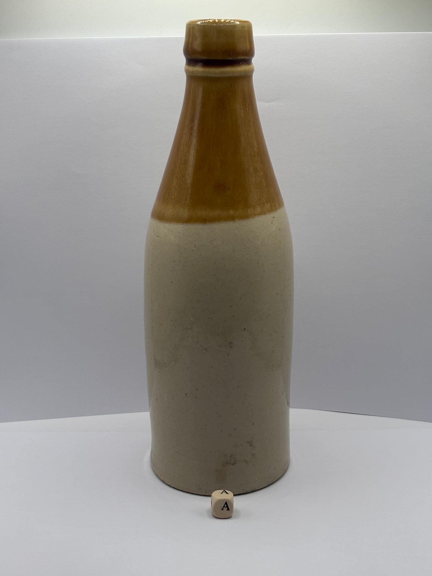Old plain stoneware ginger beer bottle (a)