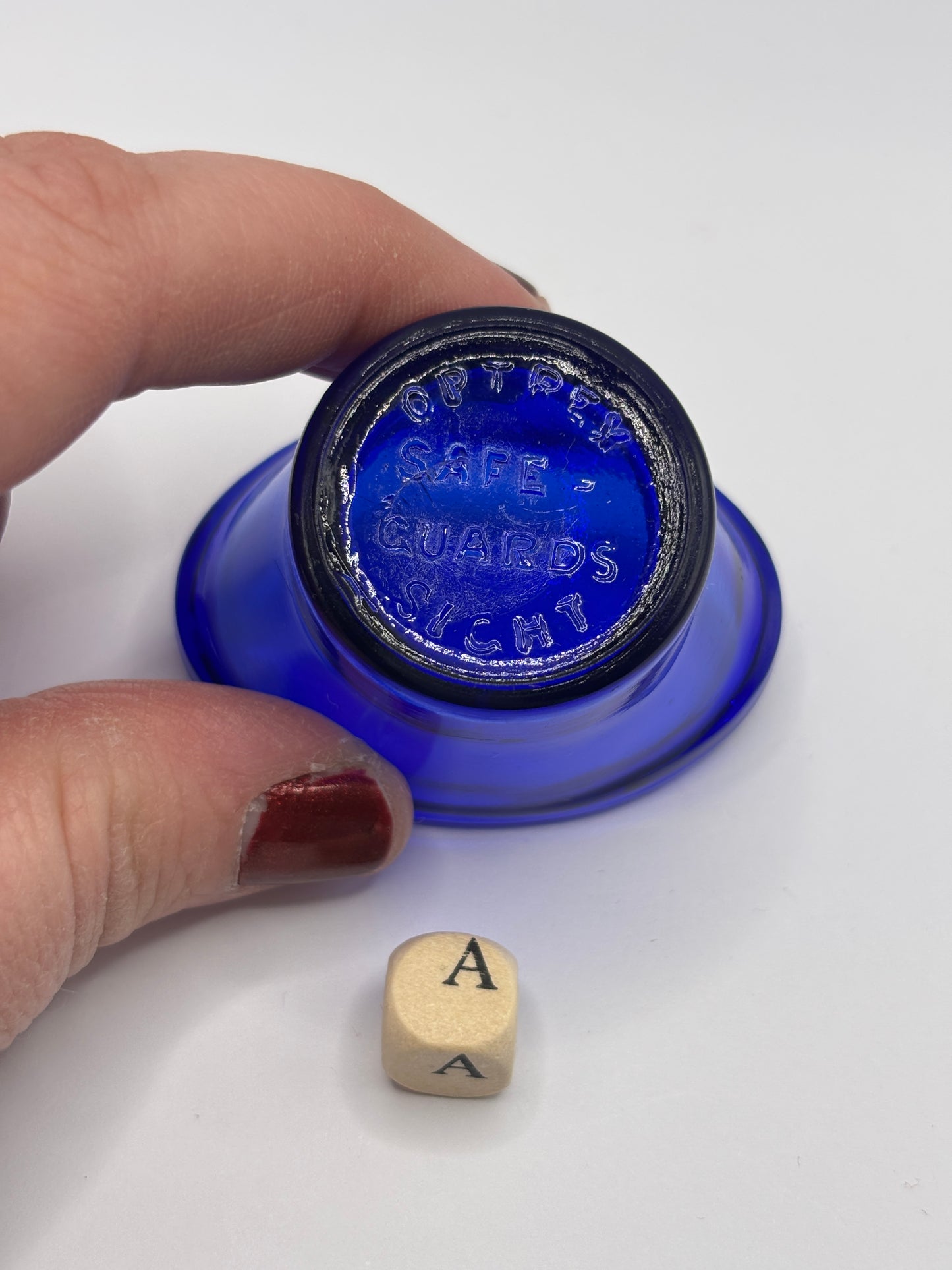 Old blue glass eye bath (a)