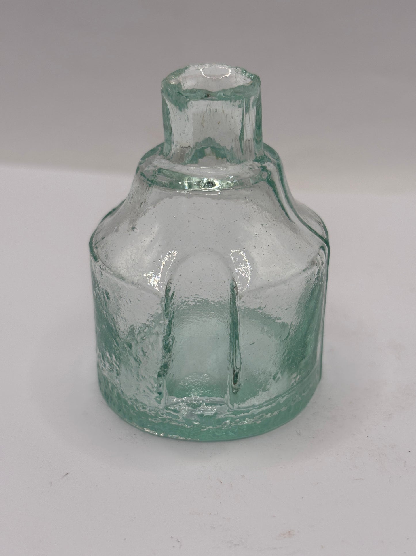Old aqua glass inkwell. Ink bottle with pen rest