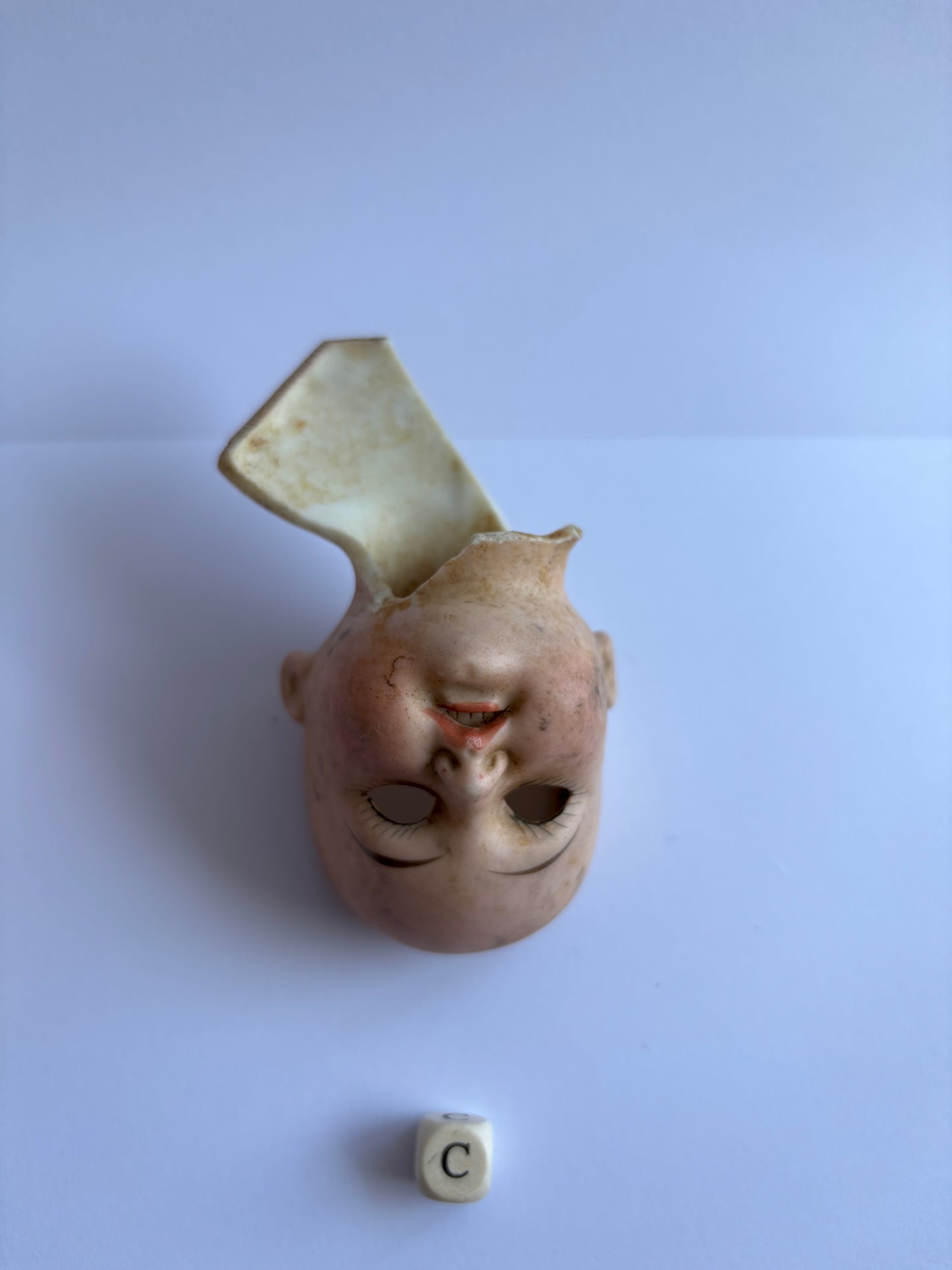 crusty old dolls head, damaged (c)