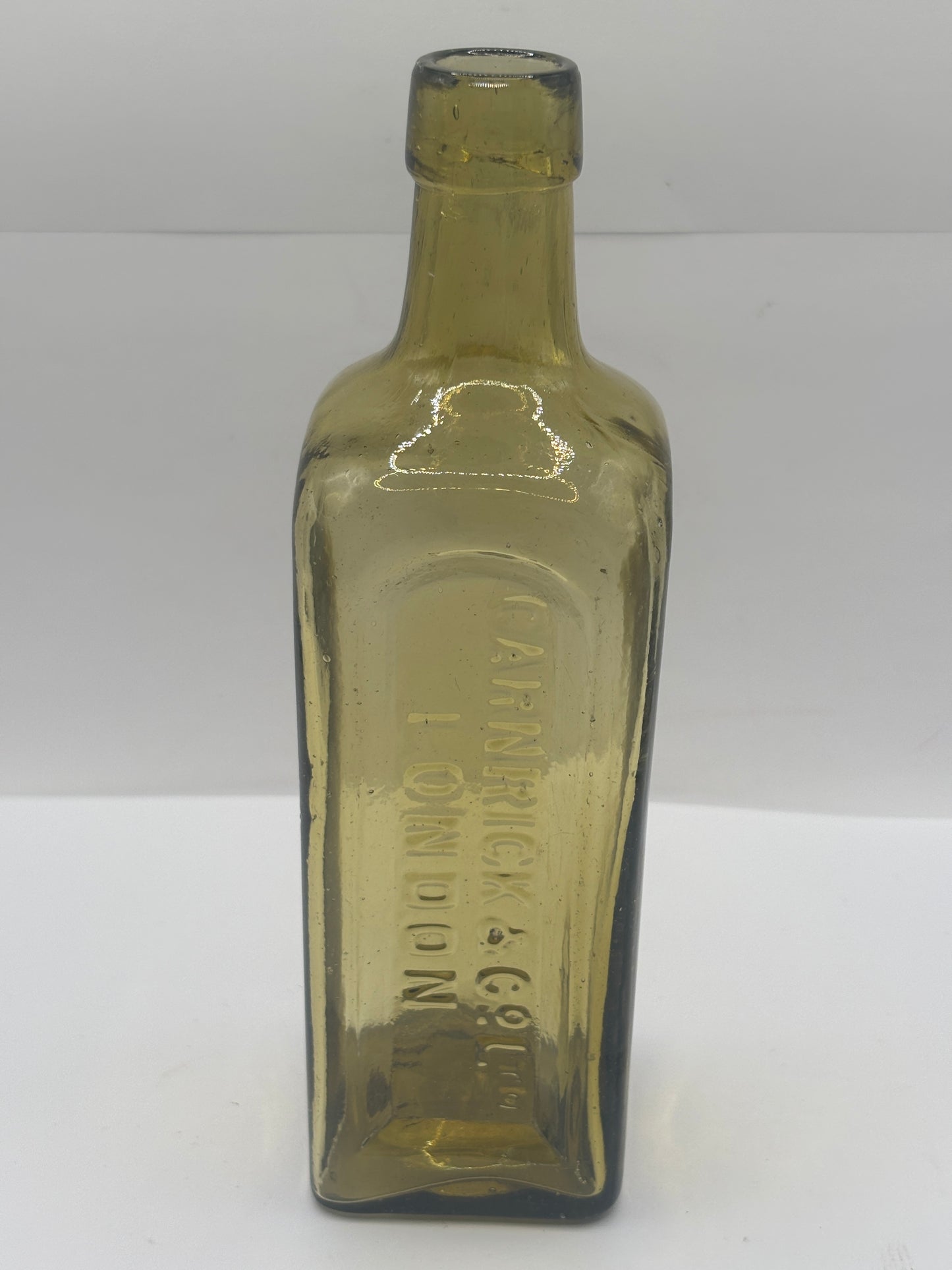 Old glass advertising chemist bottle, London