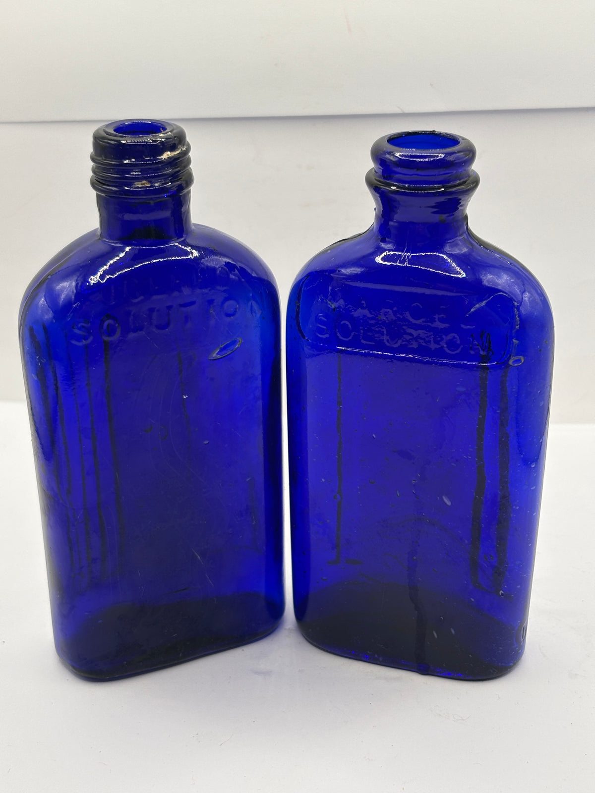 2 old blue glass ribbed poison bottes, not to be taken