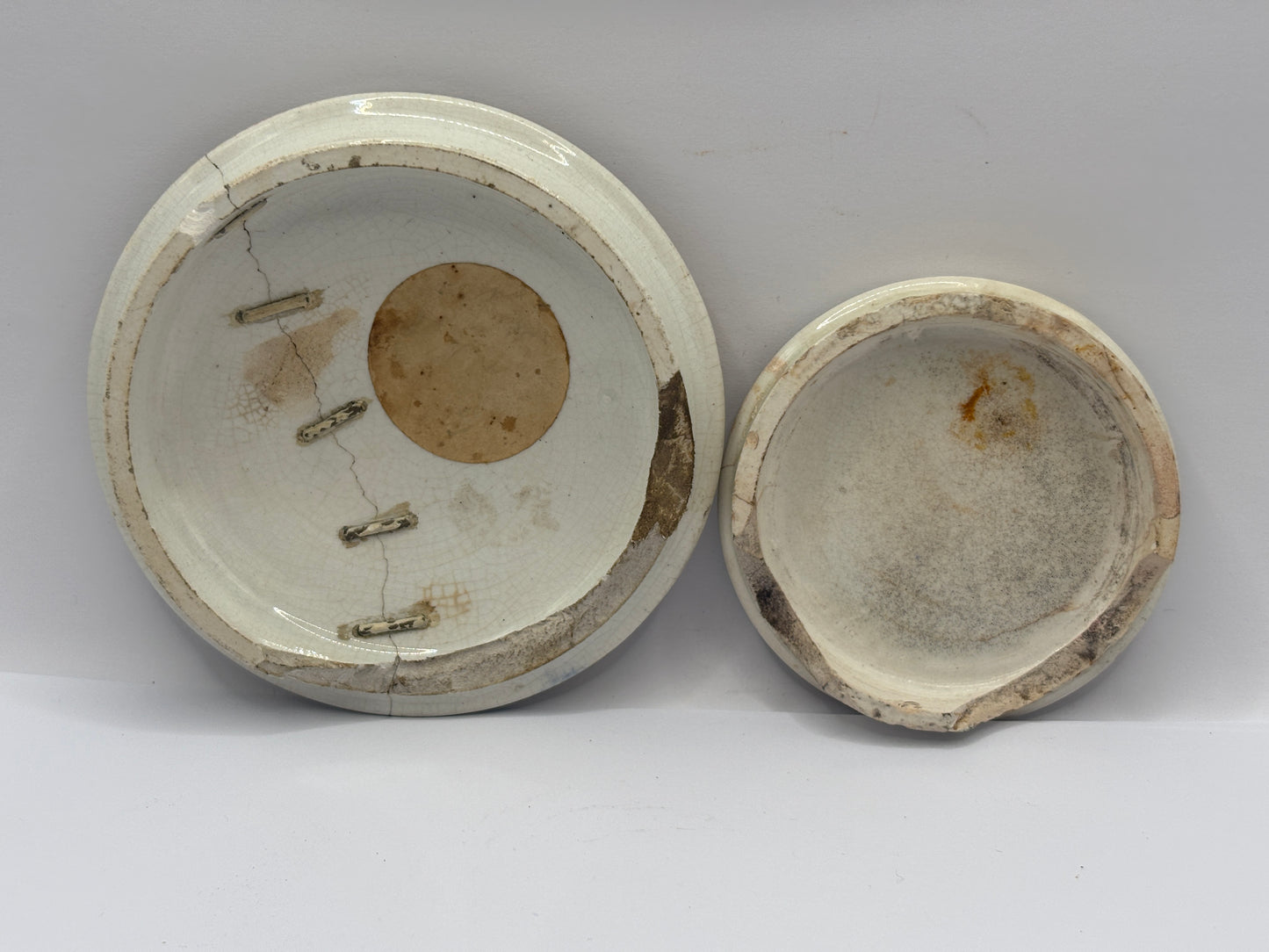 2 old damaged lids, one stapled
