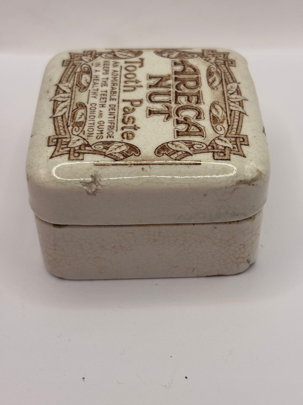 Old advertising lid and base. Areca nut toothpaste. Serpia print. Damaged