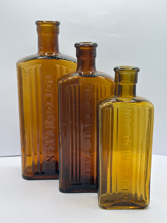 3 old amber glass poison bottles, not to be taken. Halloween