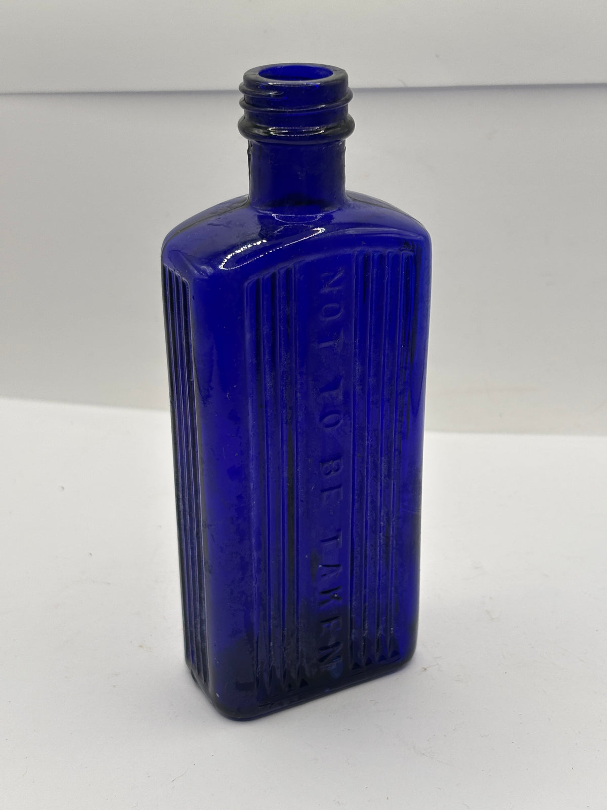 old blue glass ribbed poison bottle, not to be taken