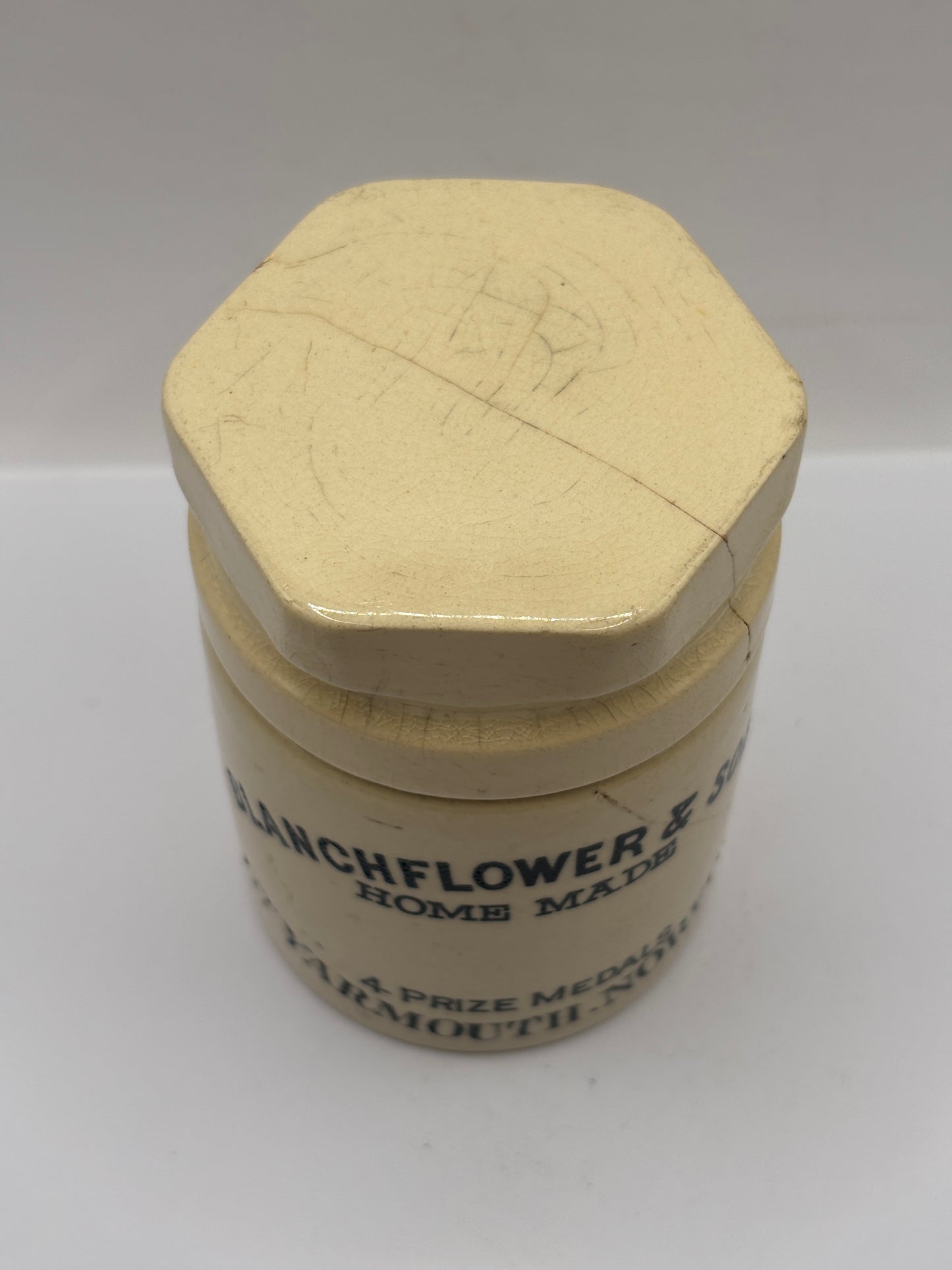 Old stoneware potted meat jar and lid. Blanchflower. Damaged