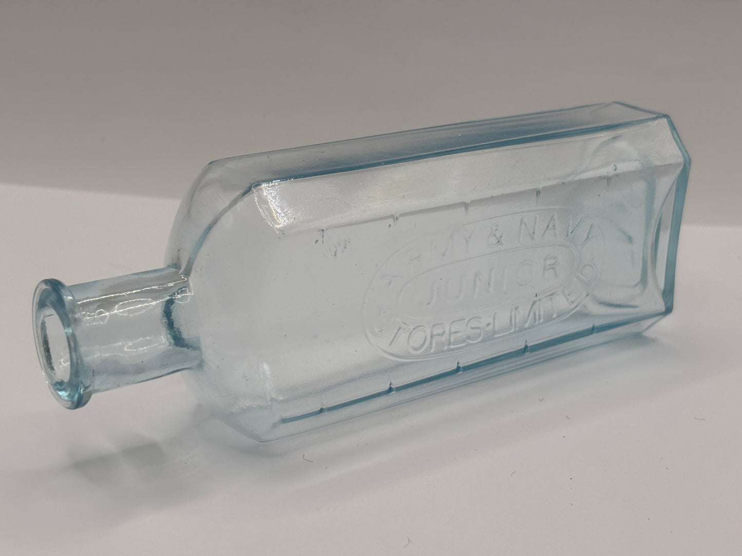 Old advertising chemist bottle. Army & navy junior stores