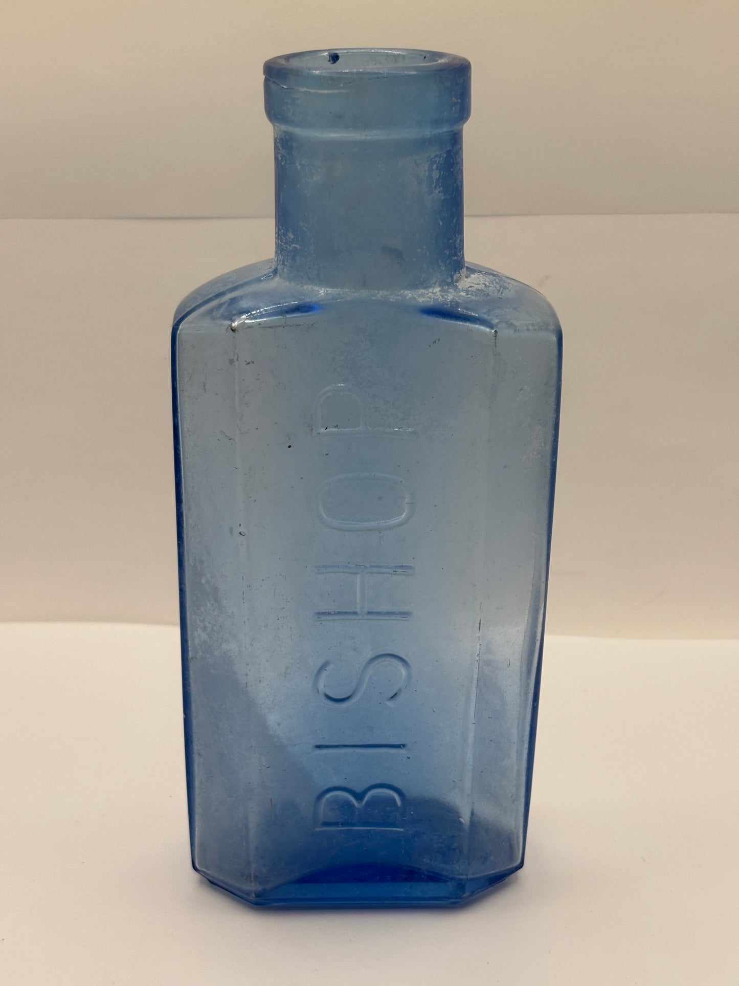 Old crusty blue glass advertising chemist bottle, Bishop