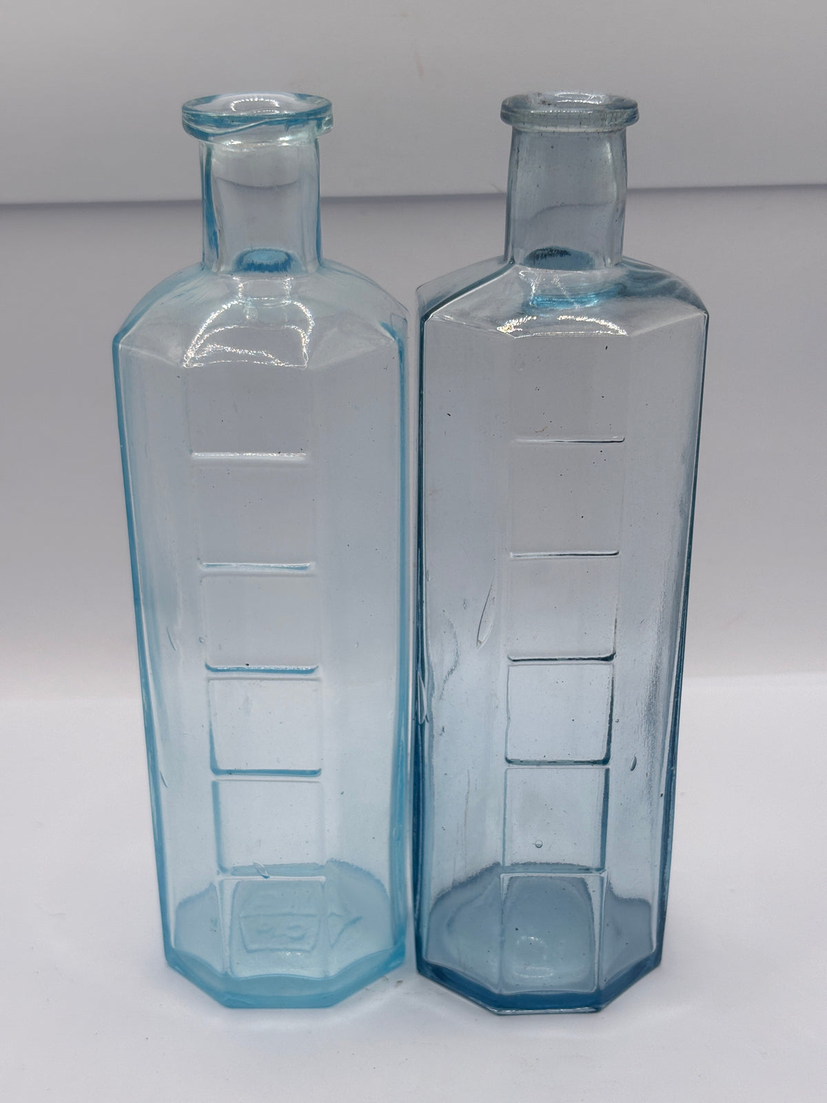 2 old glass medicine bottles