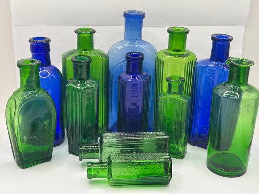 12 old coloured glass bottles, poison bottles & chemist bottles