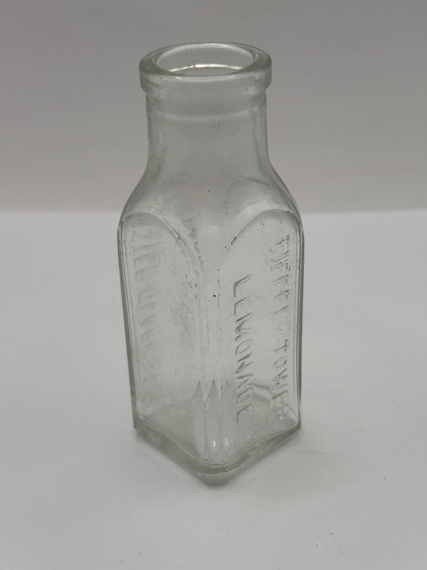 Old clear glass Eiffel tower lemonade bottle