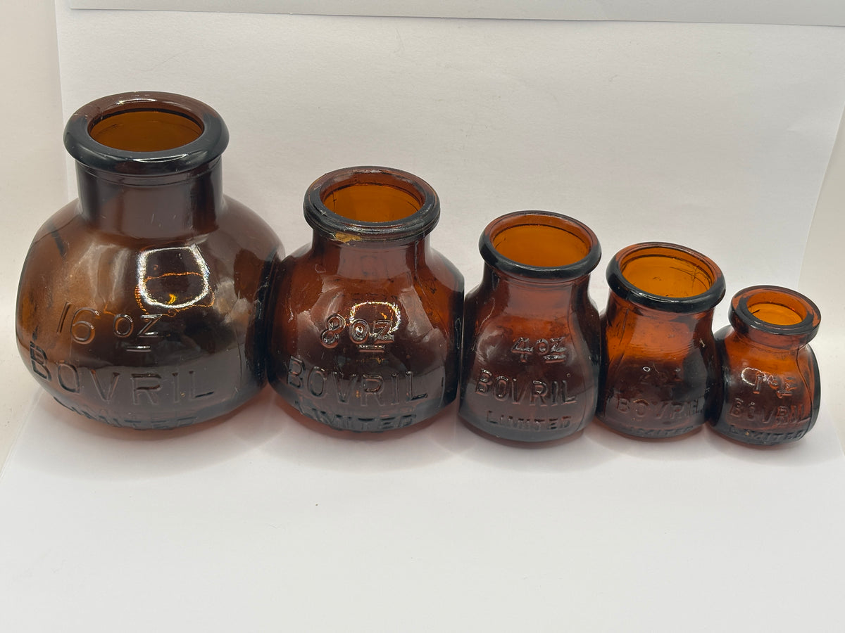 Set of 5 old amber glass Bovril bottles. 16oz- 1oz