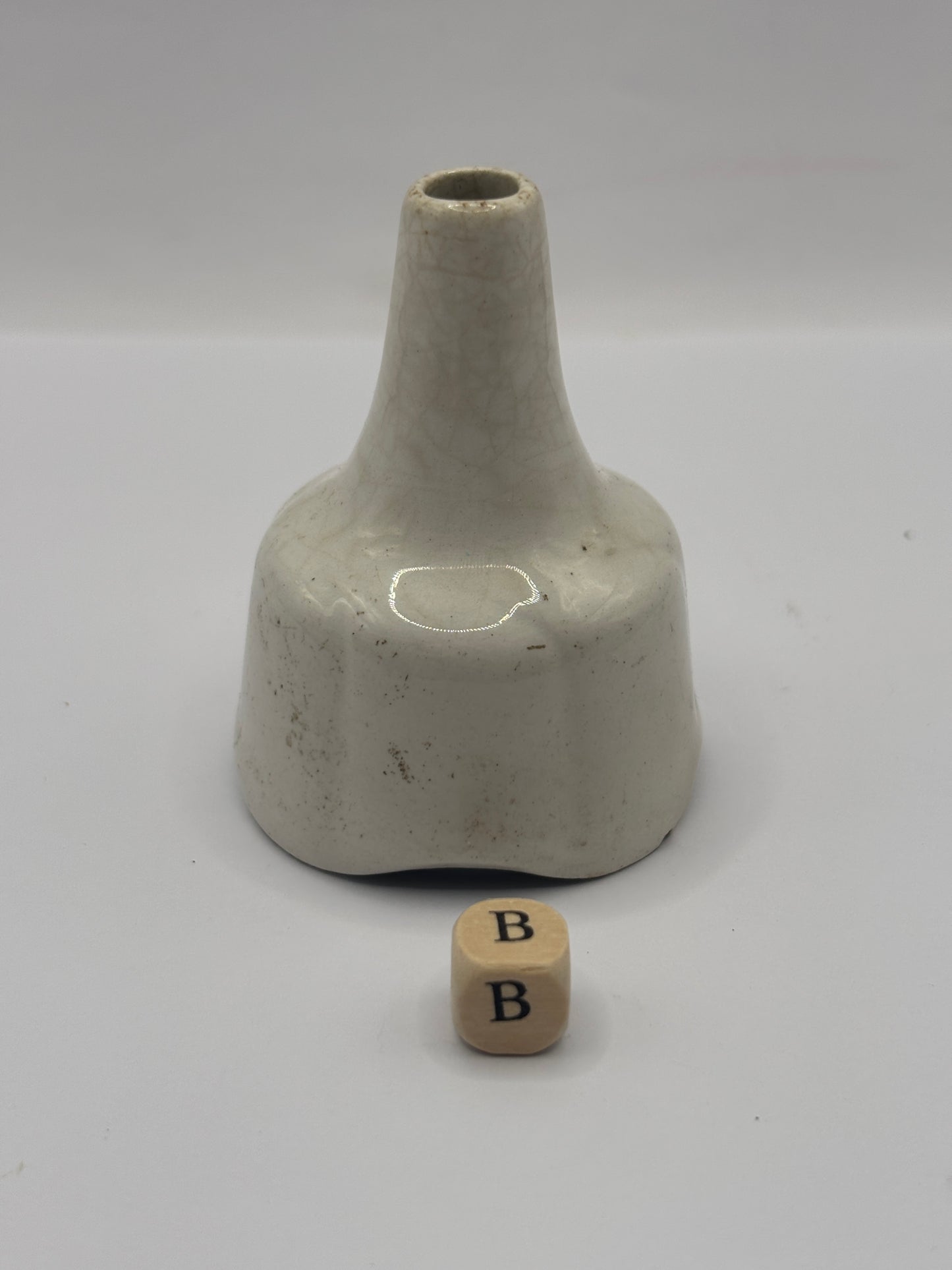 Old white stoneware pie funnel, stained & crazed. Chipped