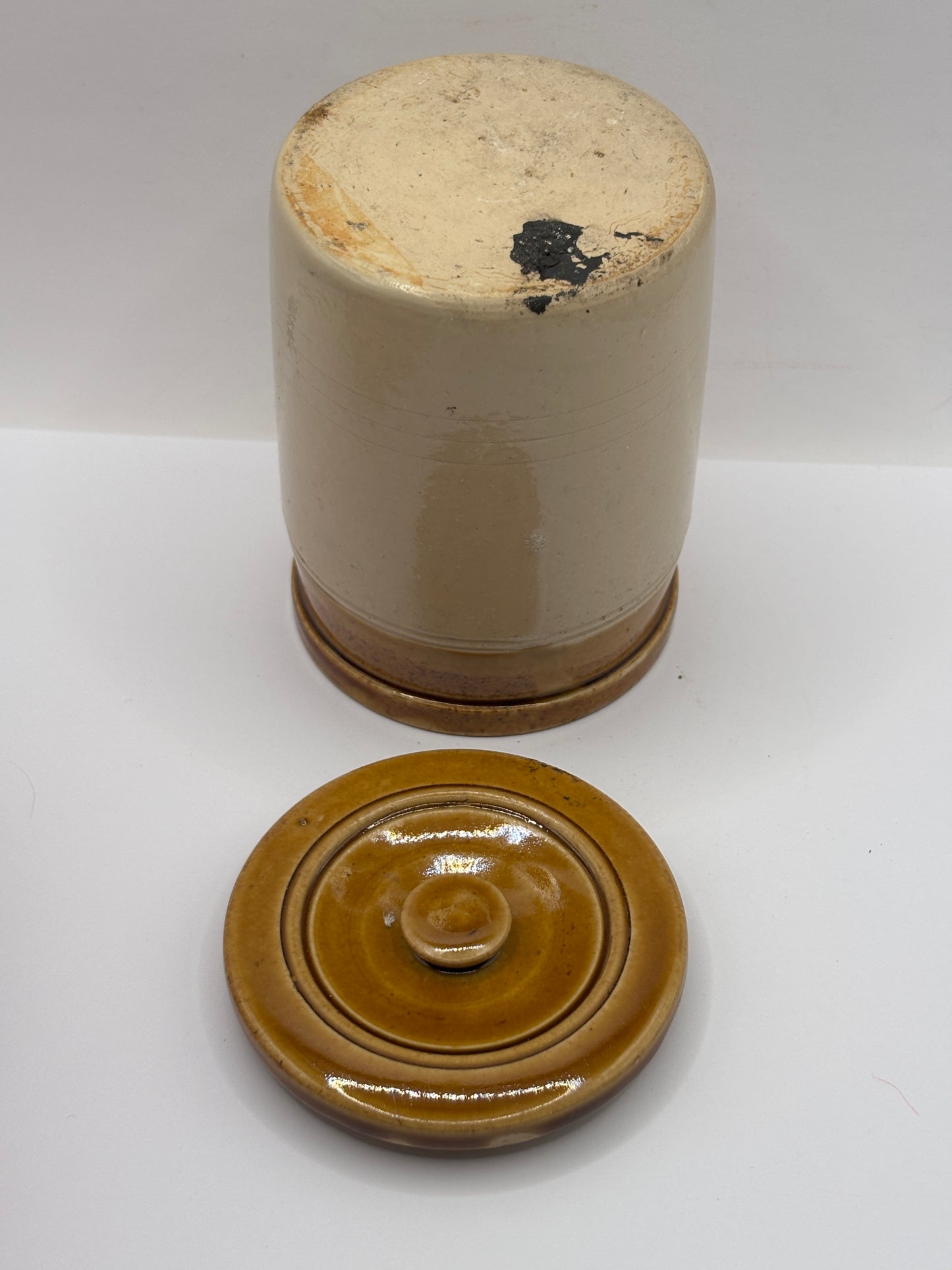 Old brown top stoneware jar and lid