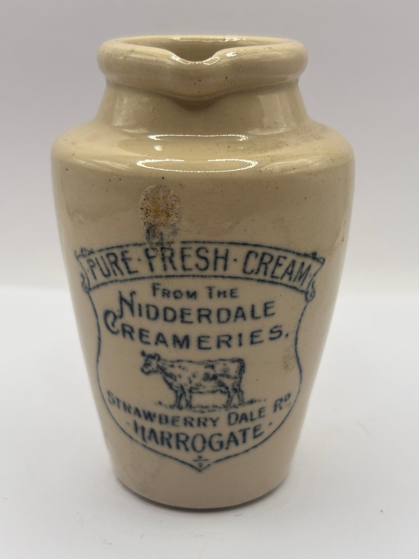 Old advertising cream pot, Nidderdale creameries. Pure fresh cream. Cow print