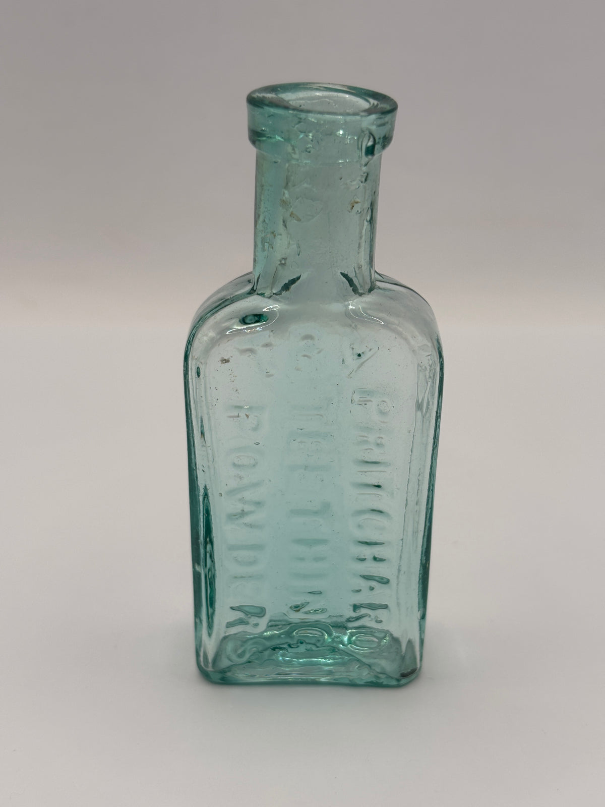 Old aqua glass advertising bottle. Try Pritchards teething powders