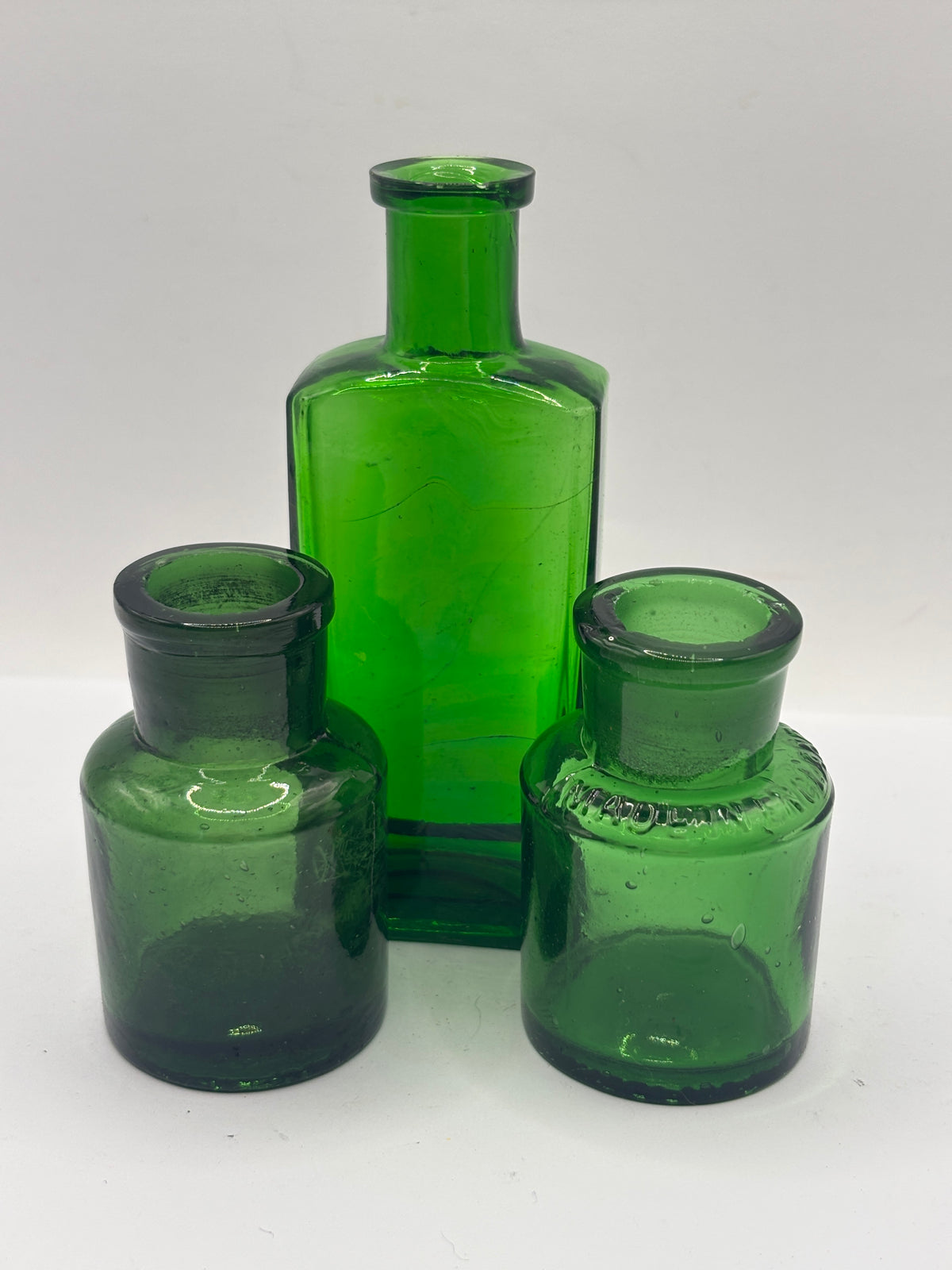 3 small old green bottles