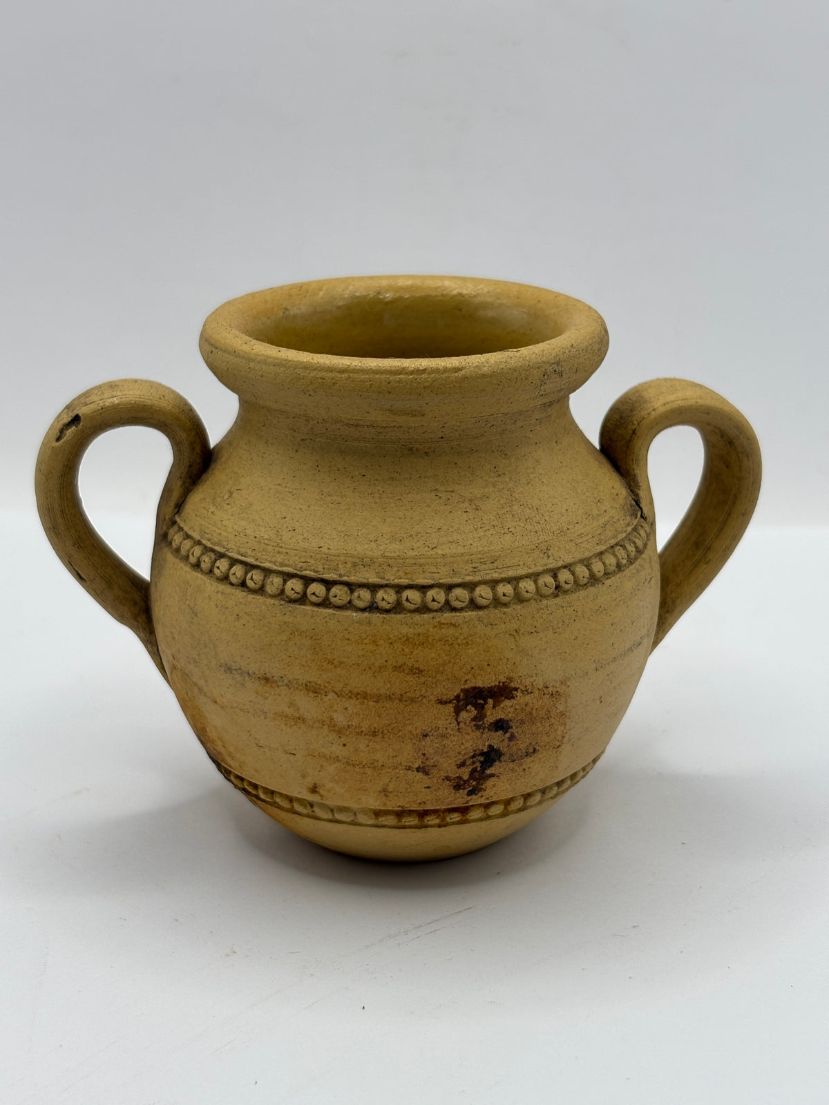 Old stained stoneware handled jug