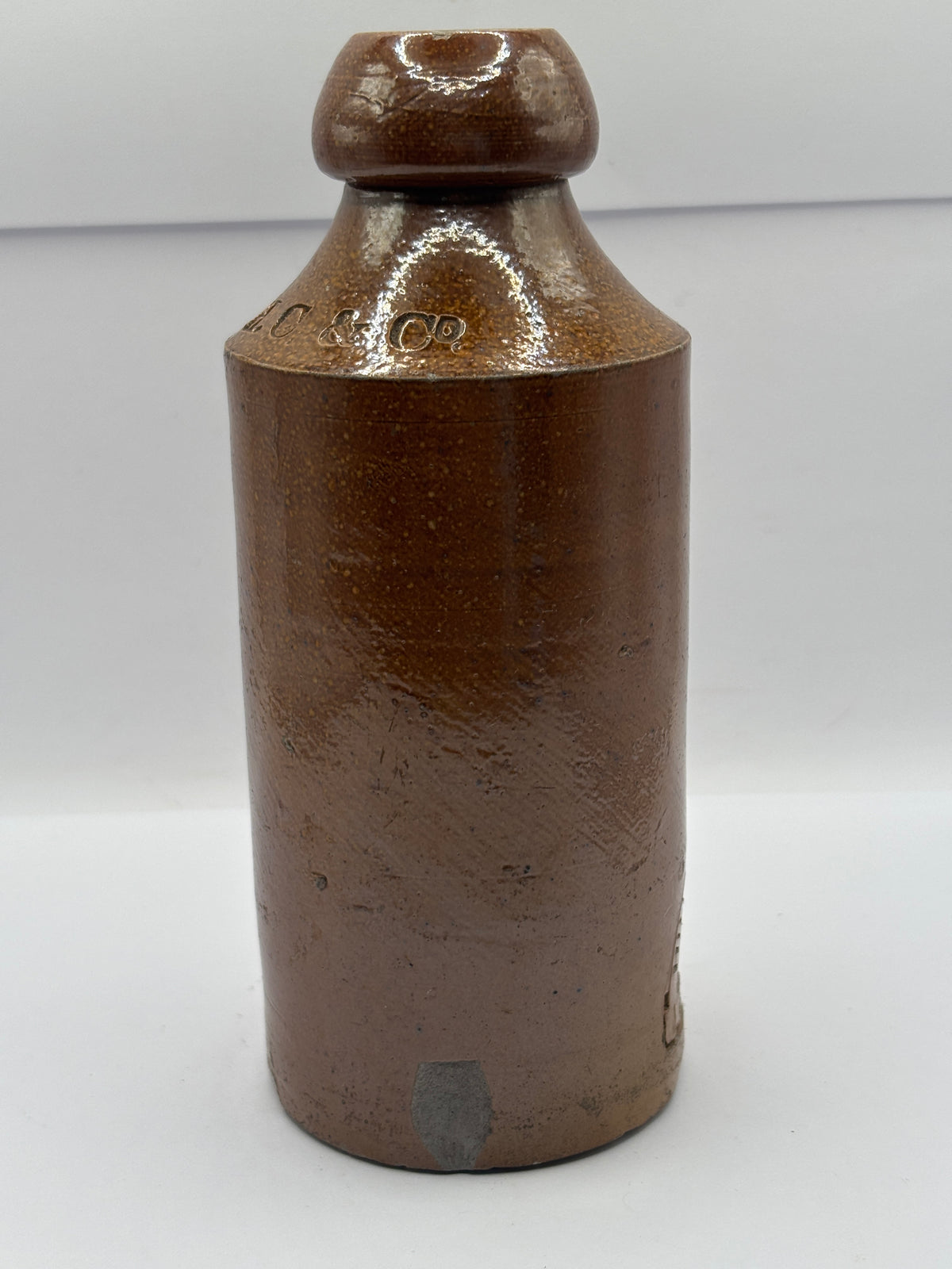 Old impressed stoneware ginger beer bottle, London. Hills chapman & co