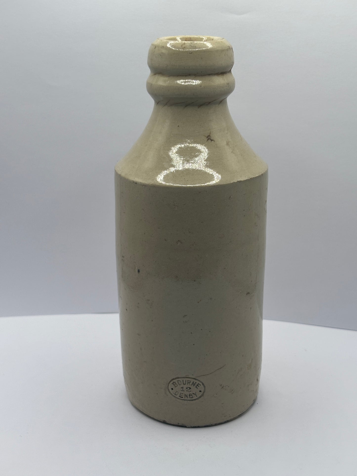 Old white stoneware Belle vue ginger beer bottle