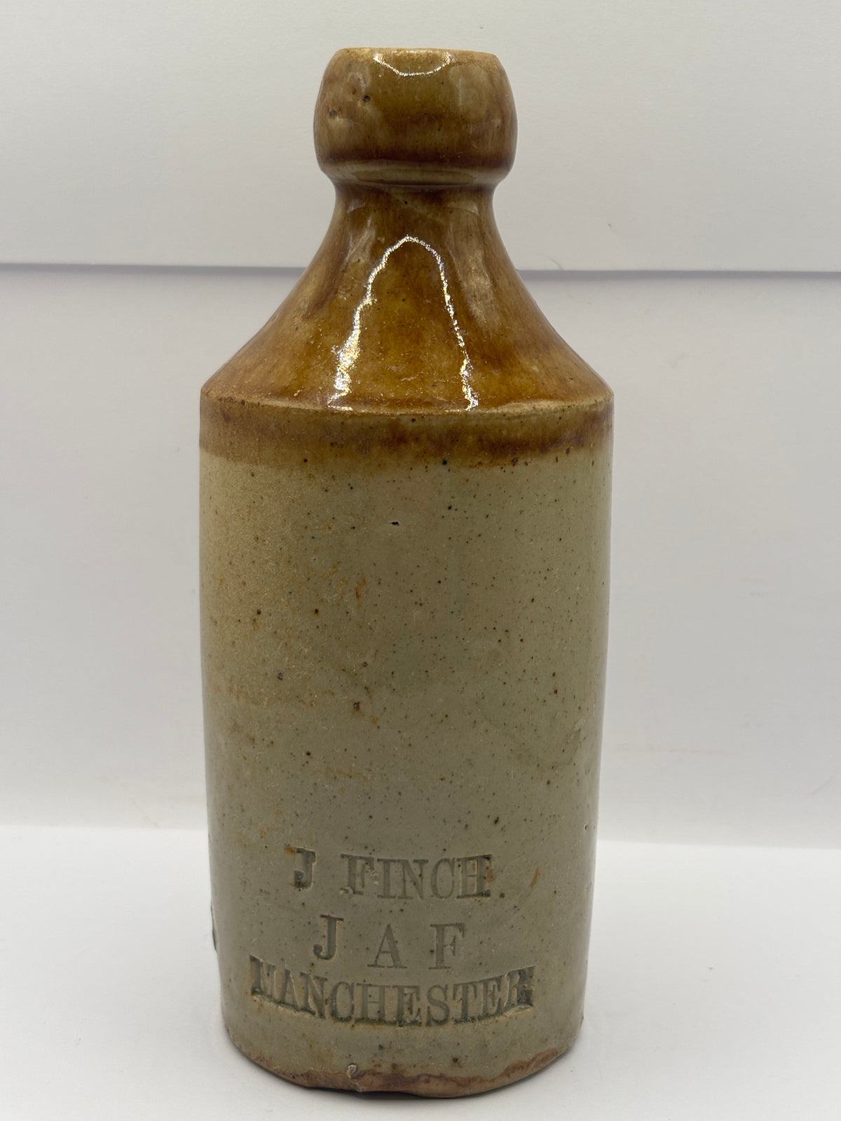 Old impressed stoneware ginger beer bottle, Manchester. J.Finch