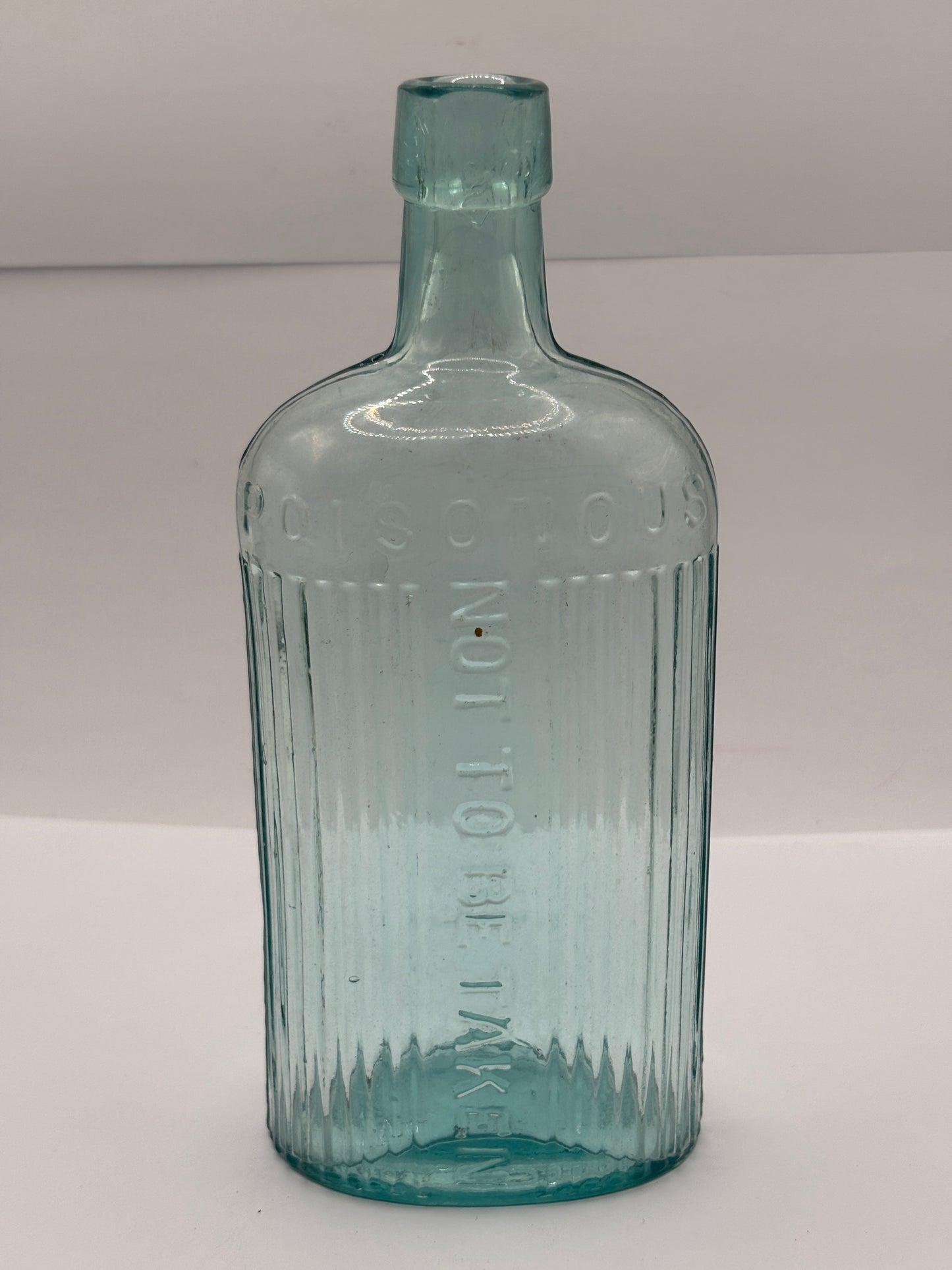 Old aqua glass poison bottle, not to be taken