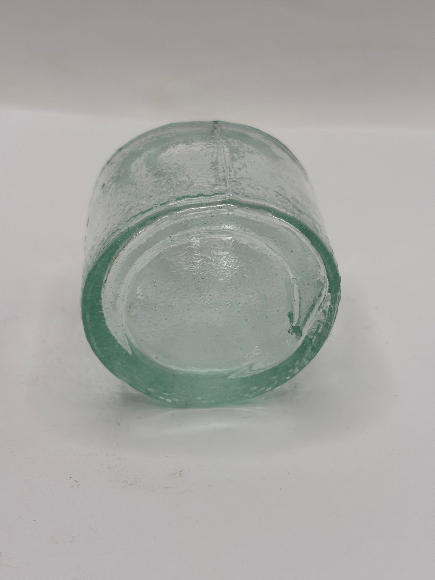 Old aqua glass inkwell. Ink bottle with pen rest