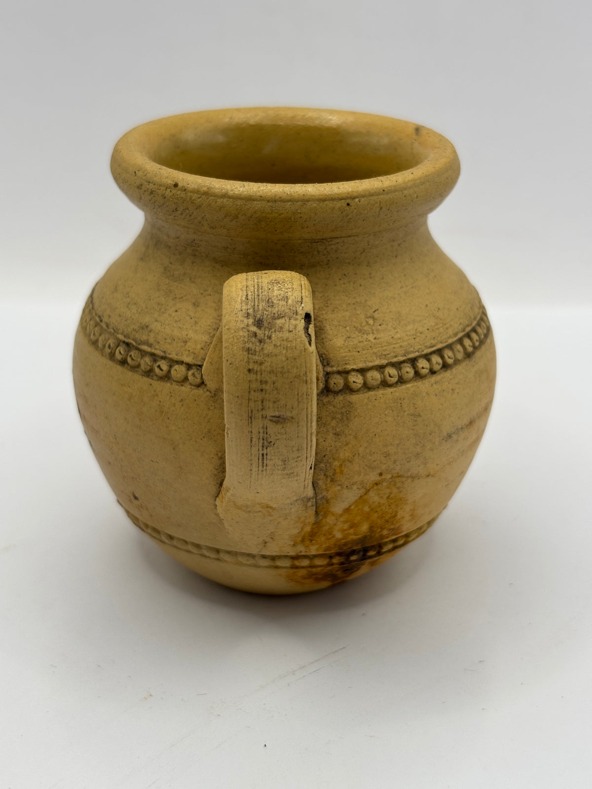 Old stained stoneware handled jug