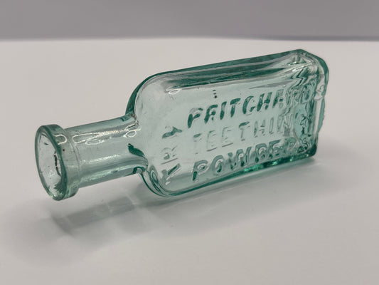 Old aqua glass advertising chemist bottle. Pritchards teething powder