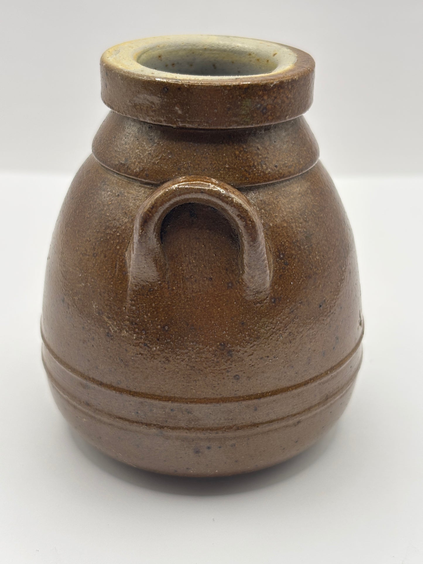 Old brown stoneware Benoist jar