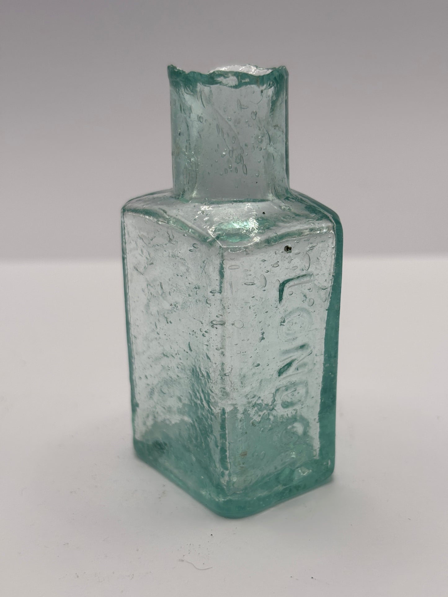 Old aqua glass advertising inkwell. Judson London