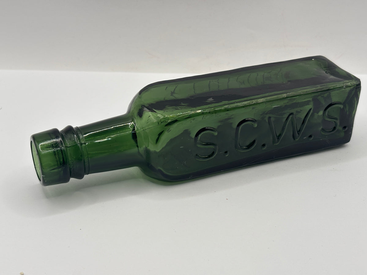 Old green glass essence of coffee bottle
