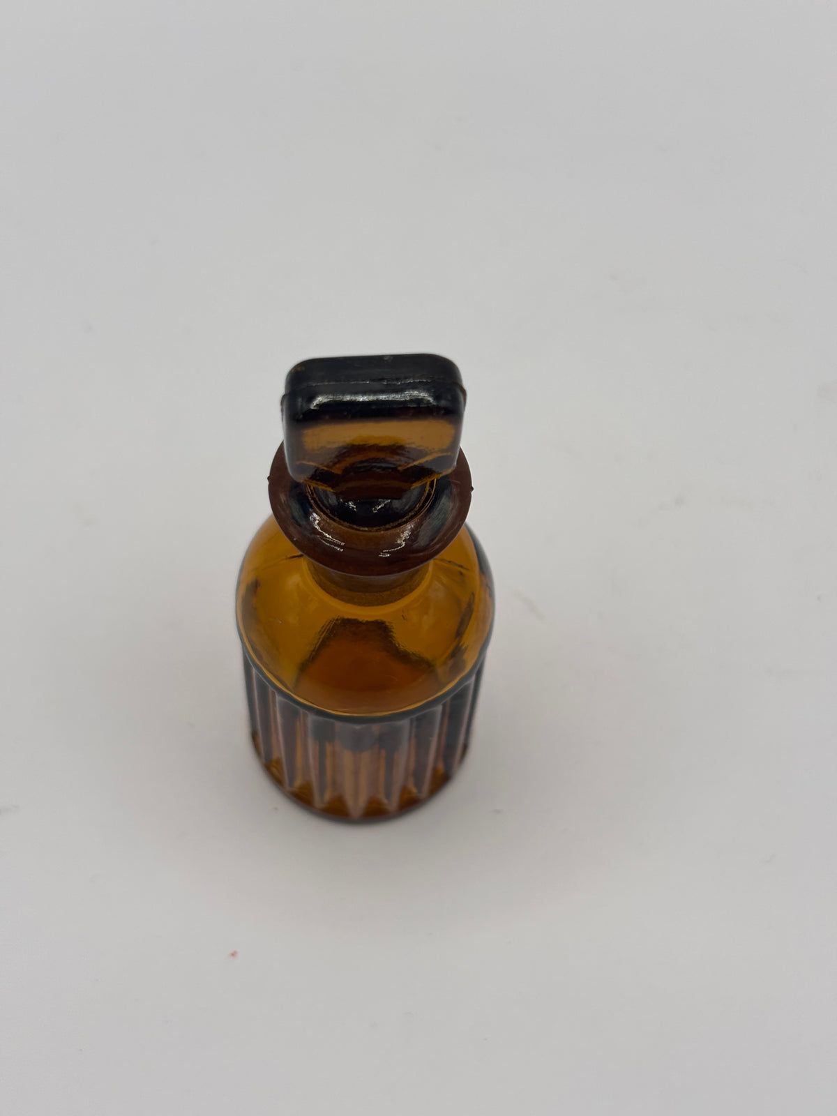 Small amber glass poison bottle with original stopper