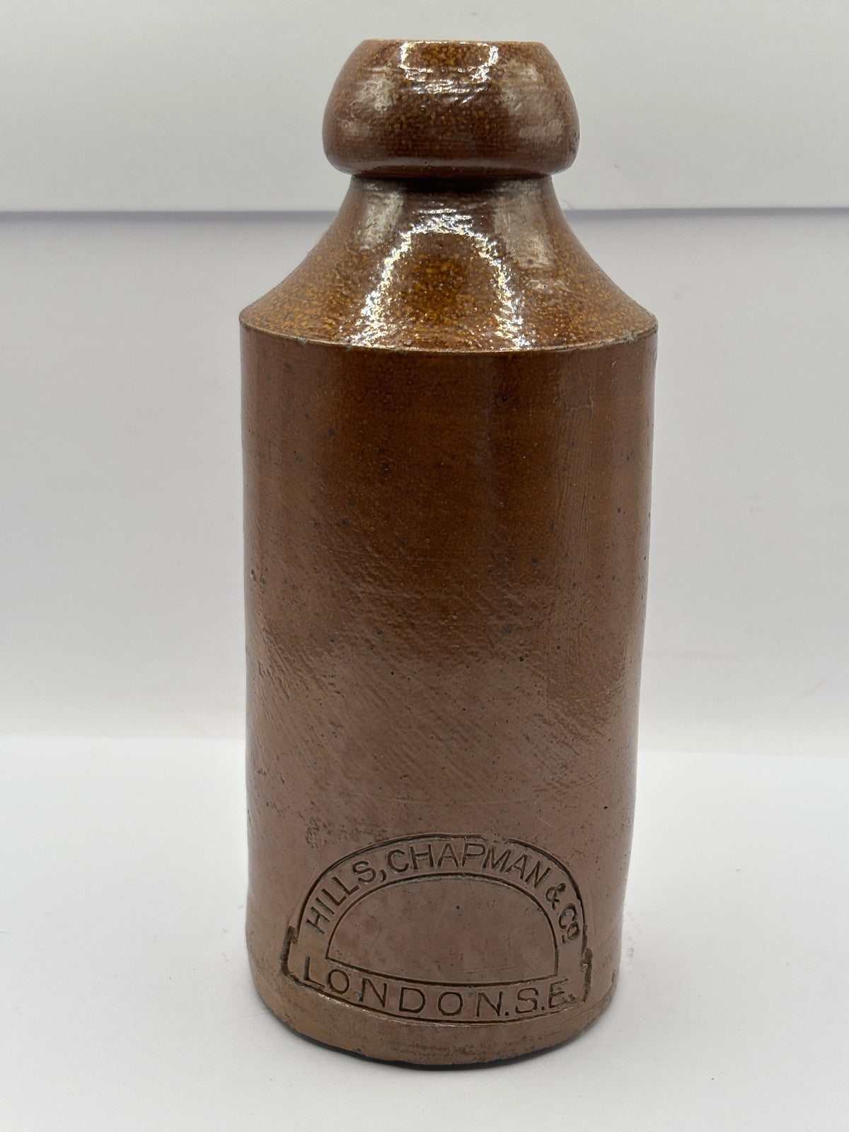 Old impressed stoneware ginger beer bottle, London. Hills chapman & co