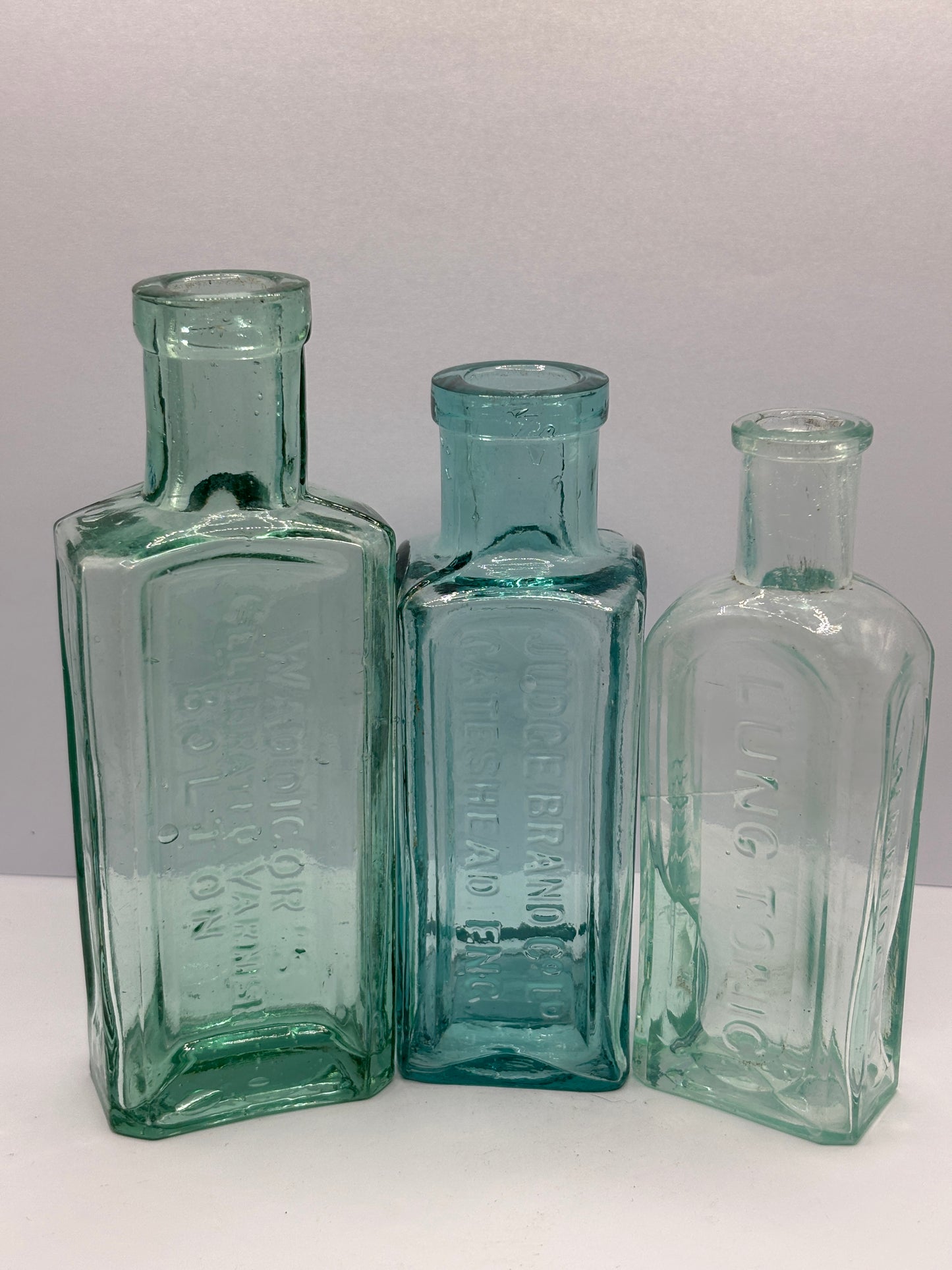 3 old aqua glass advertising chemist bottles