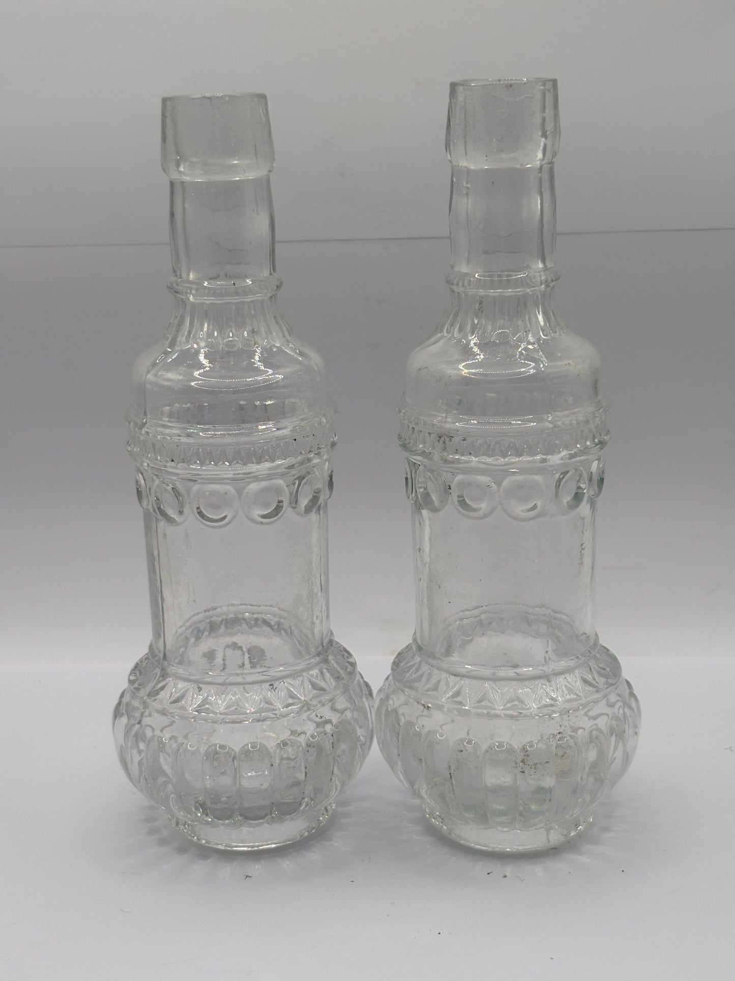 2 old clear glass bottles, soda?