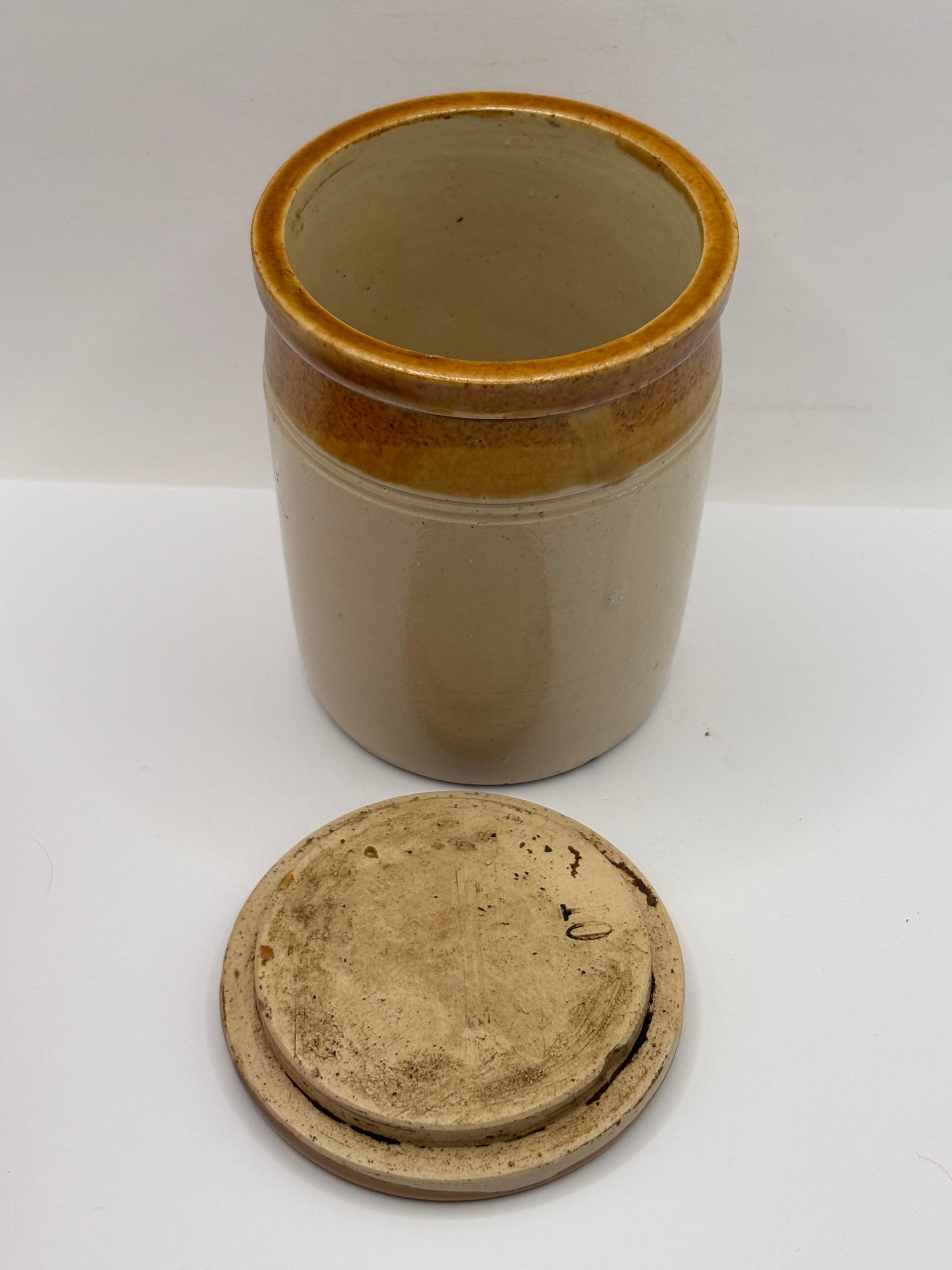Old brown top stoneware jar and lid