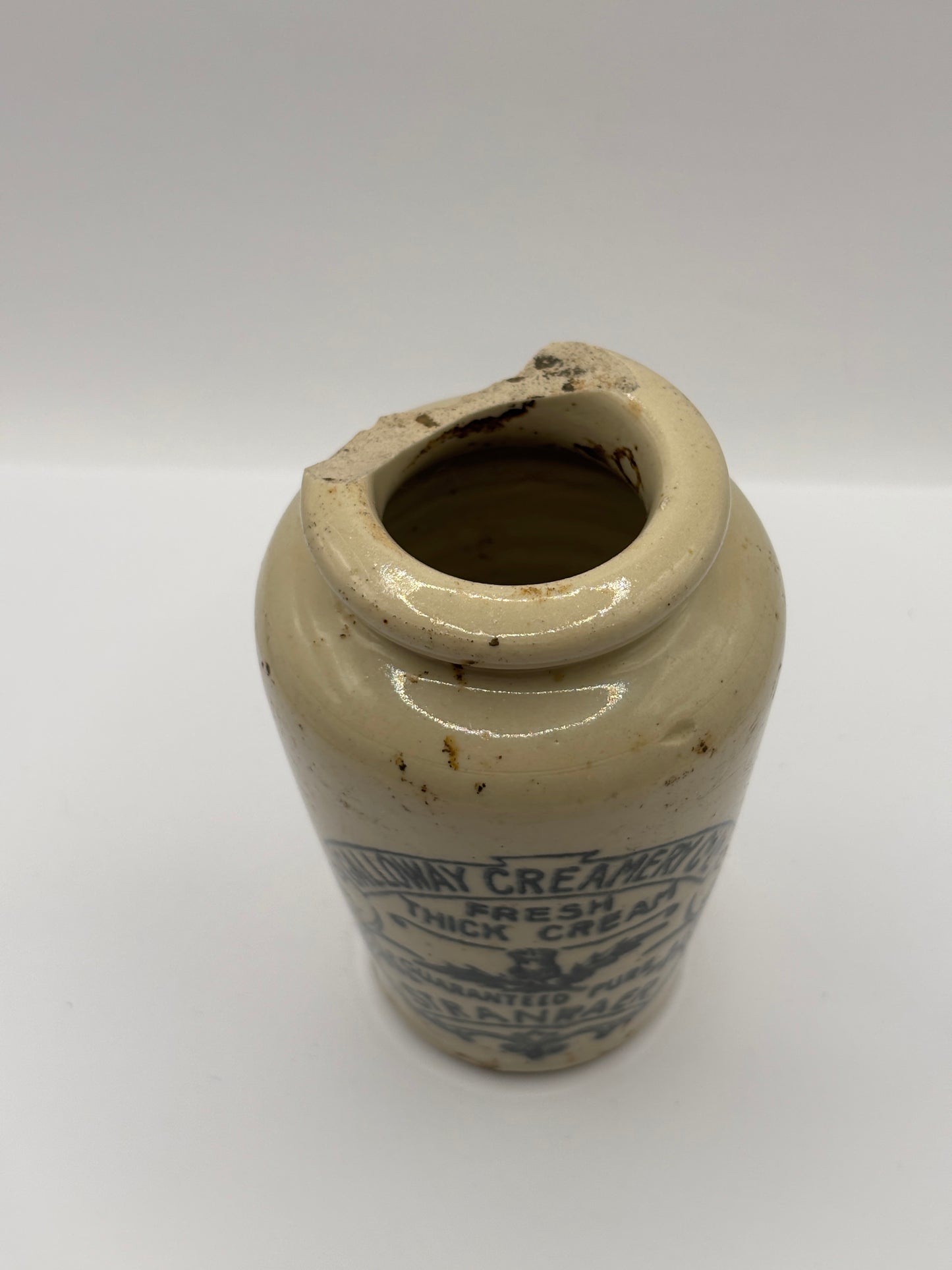 Old advertising cream pot, Galloway creamery Stranraer. Damaged