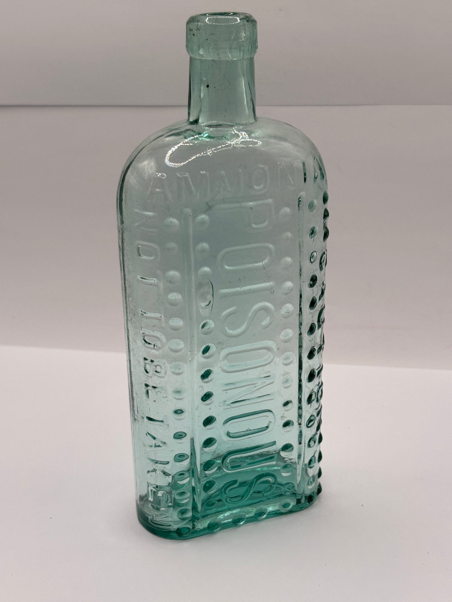 Old aqua glass poison bottle, Ammonia, caution Poisonous, not to be taken