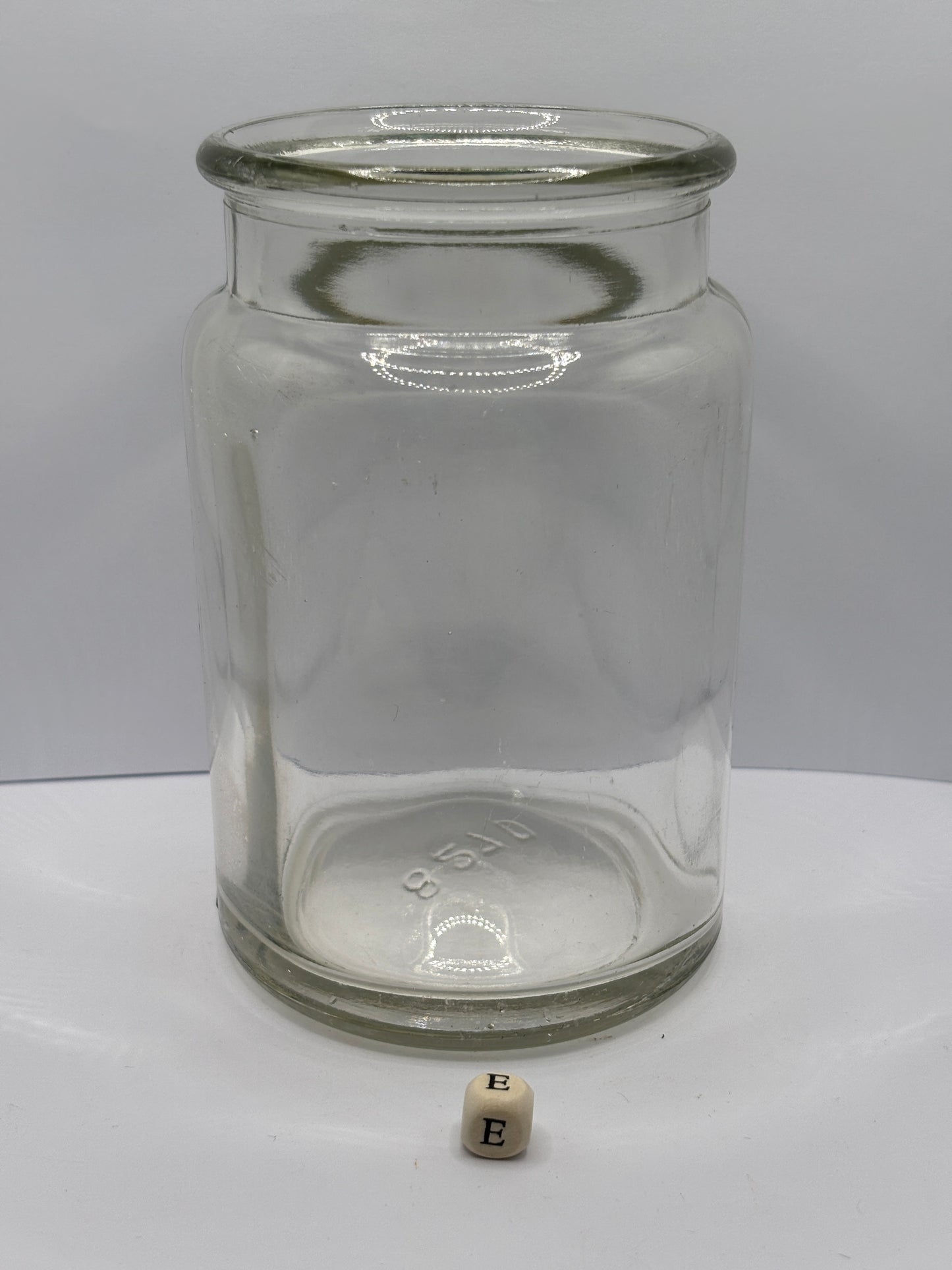 Old clear glass jam jar (e)